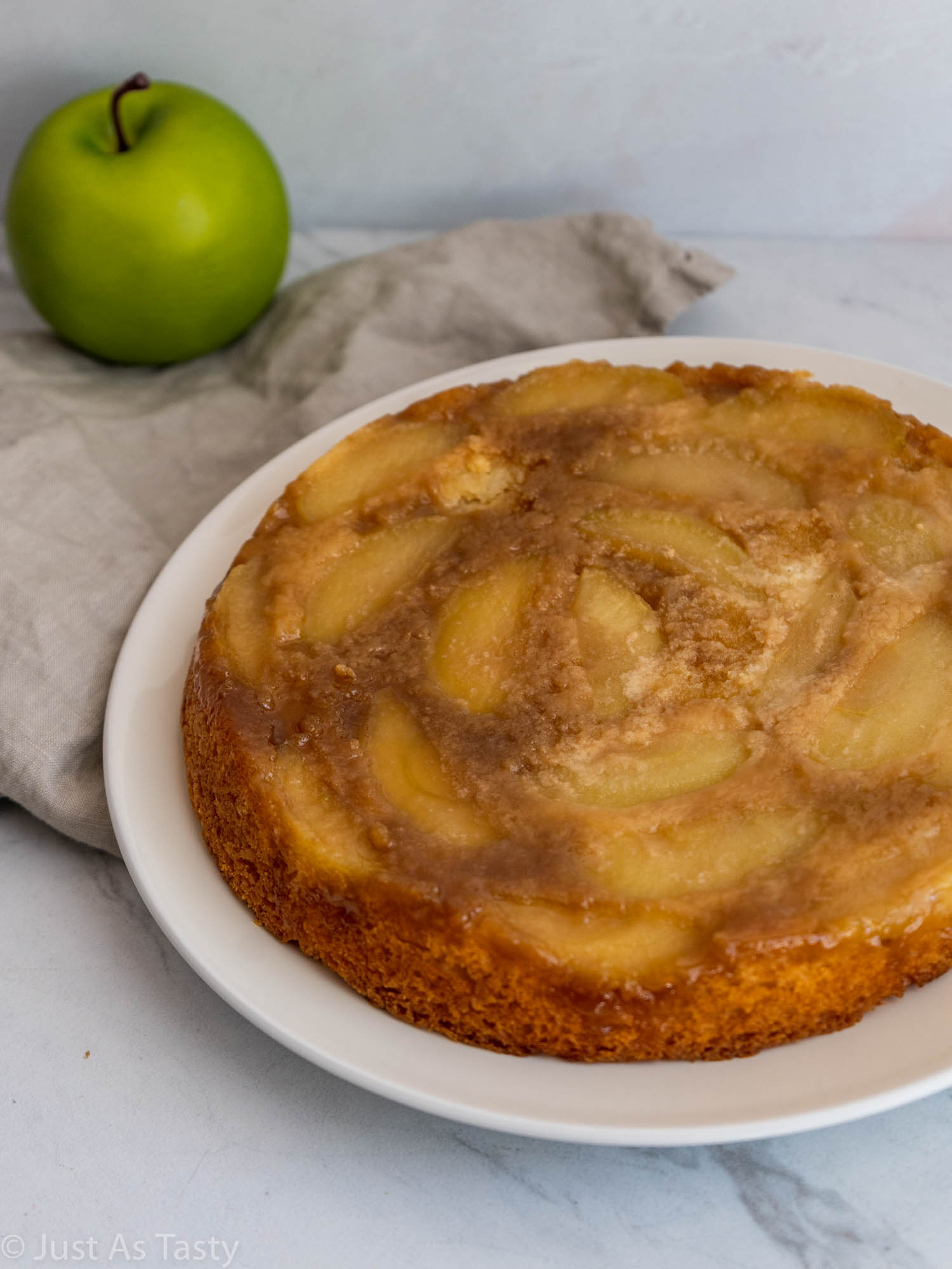 Gluten free single-layer apple cake on a white plate.