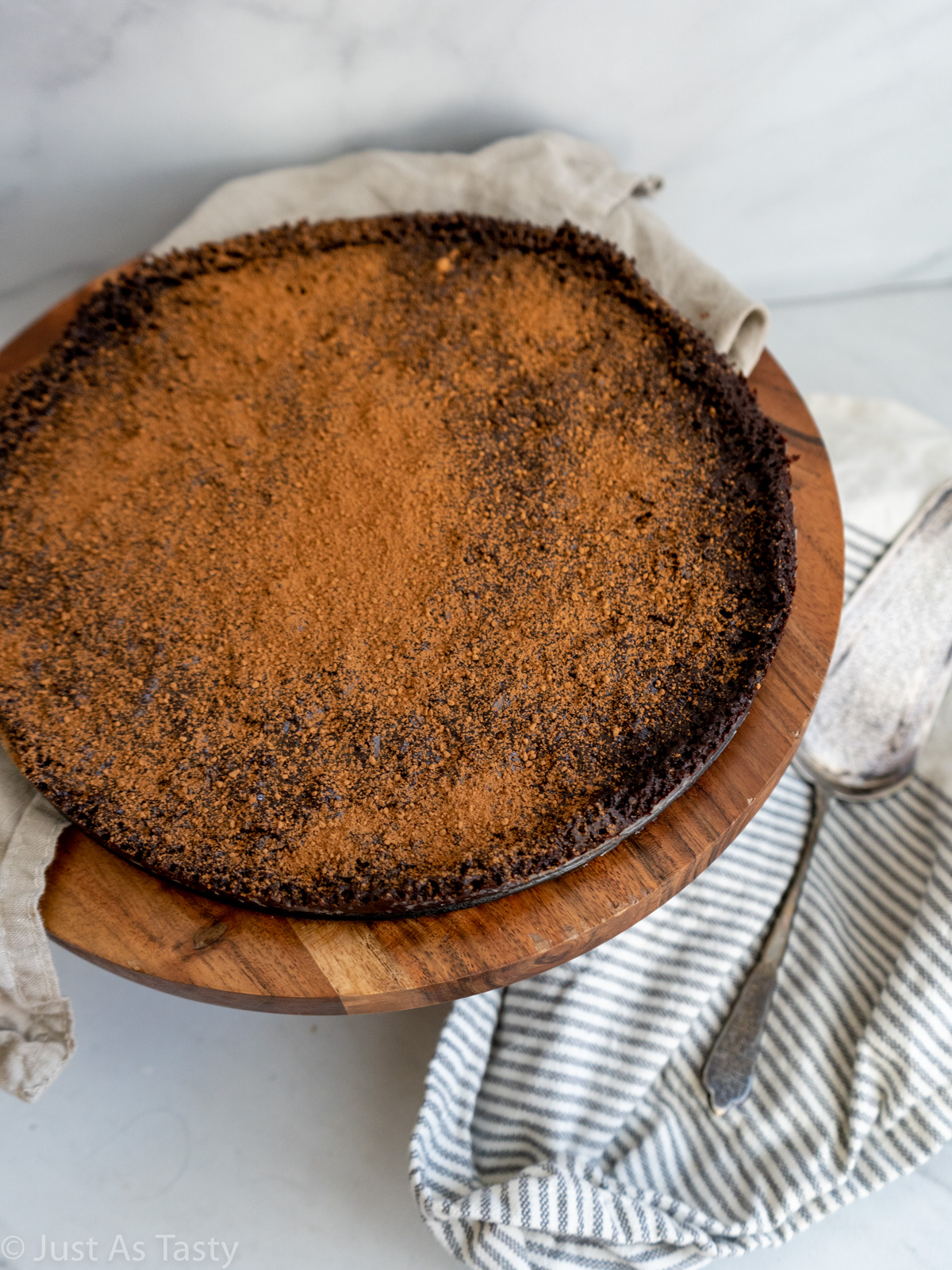 Flourless chocolate cake topped with cocoa powder.