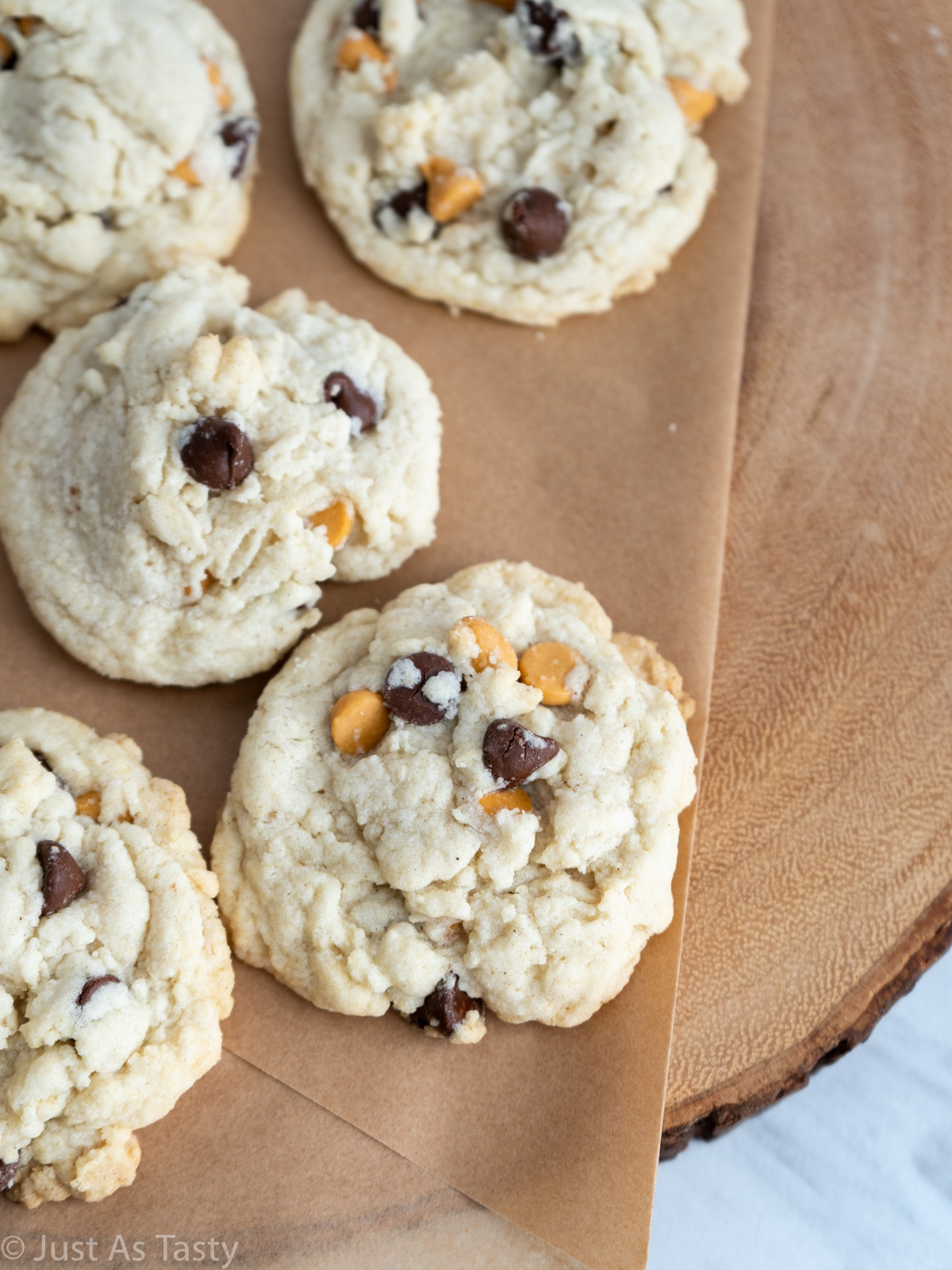 Close-up of butterscotch chip cookies on a brown surface. 