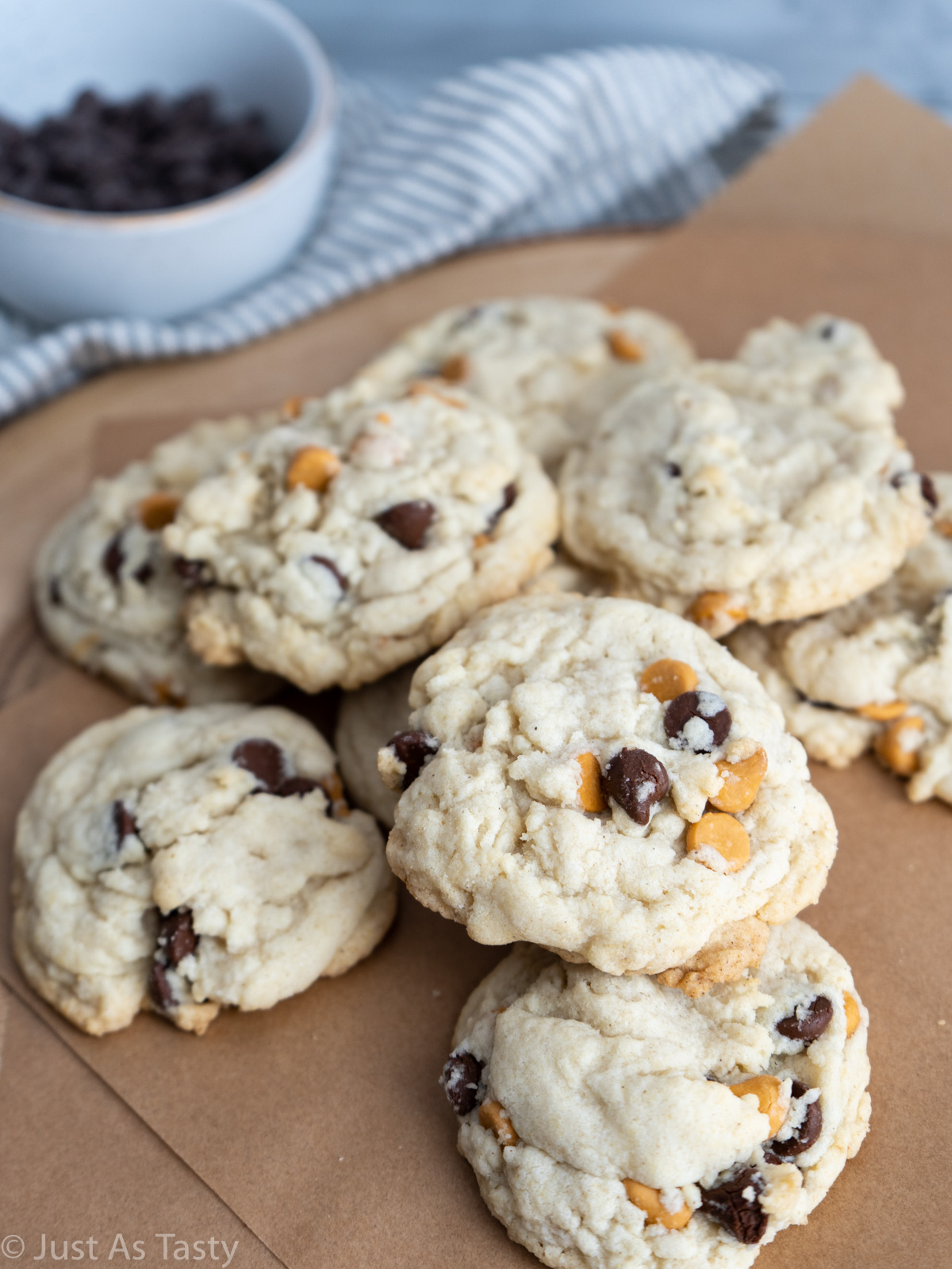 Butterscotch chocolate chip cookies on brown parchment paper.