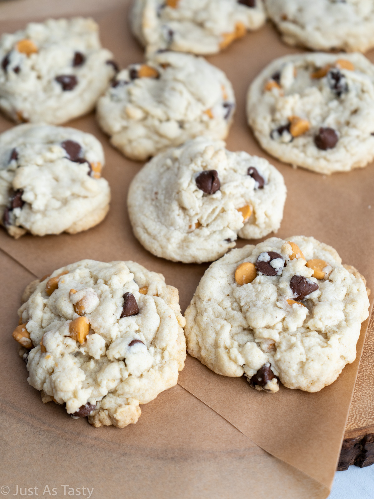 Butterscotch chocolate chip cookies on a brown surface. 