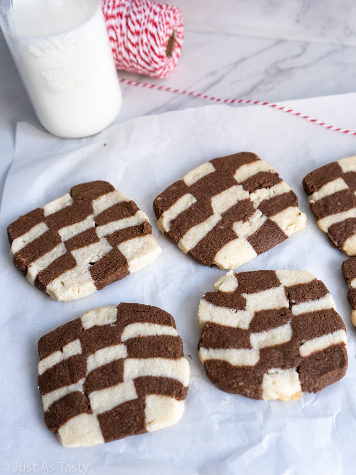Checkerboard cookies on white parchment paper.