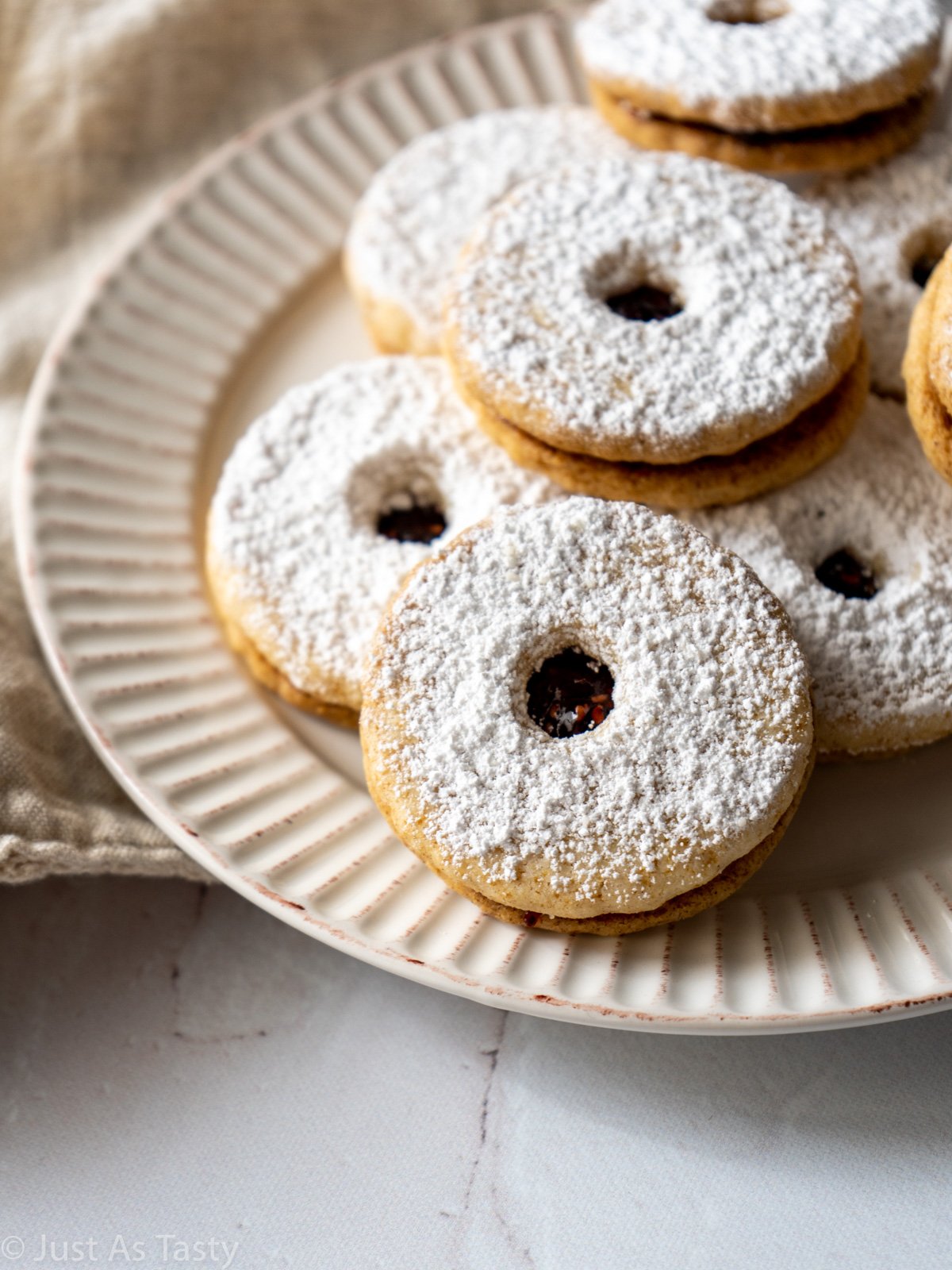 Close-up of Linzer cookie dusted with powdered sugar.