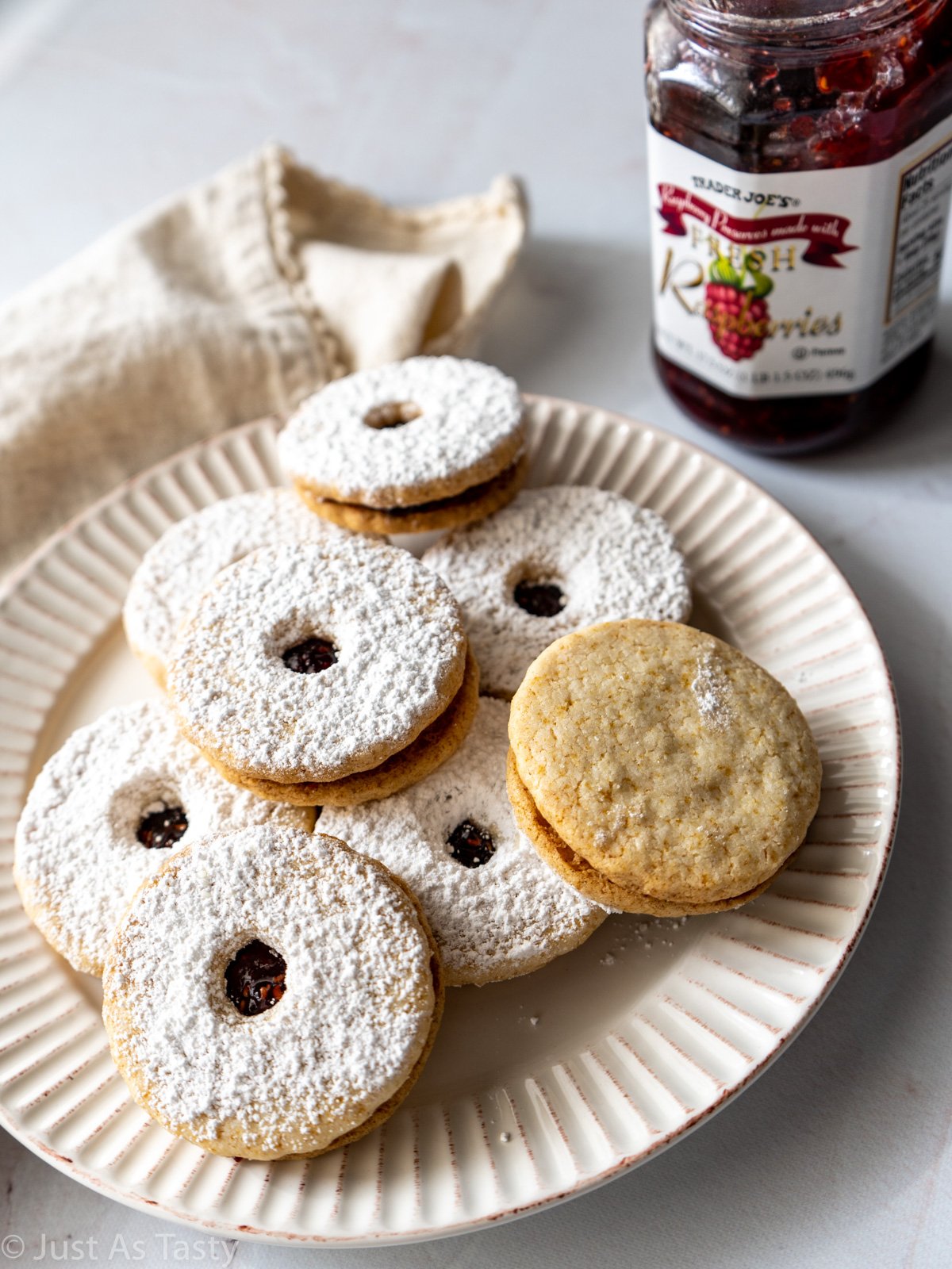 Linzer cookies on a white plate.