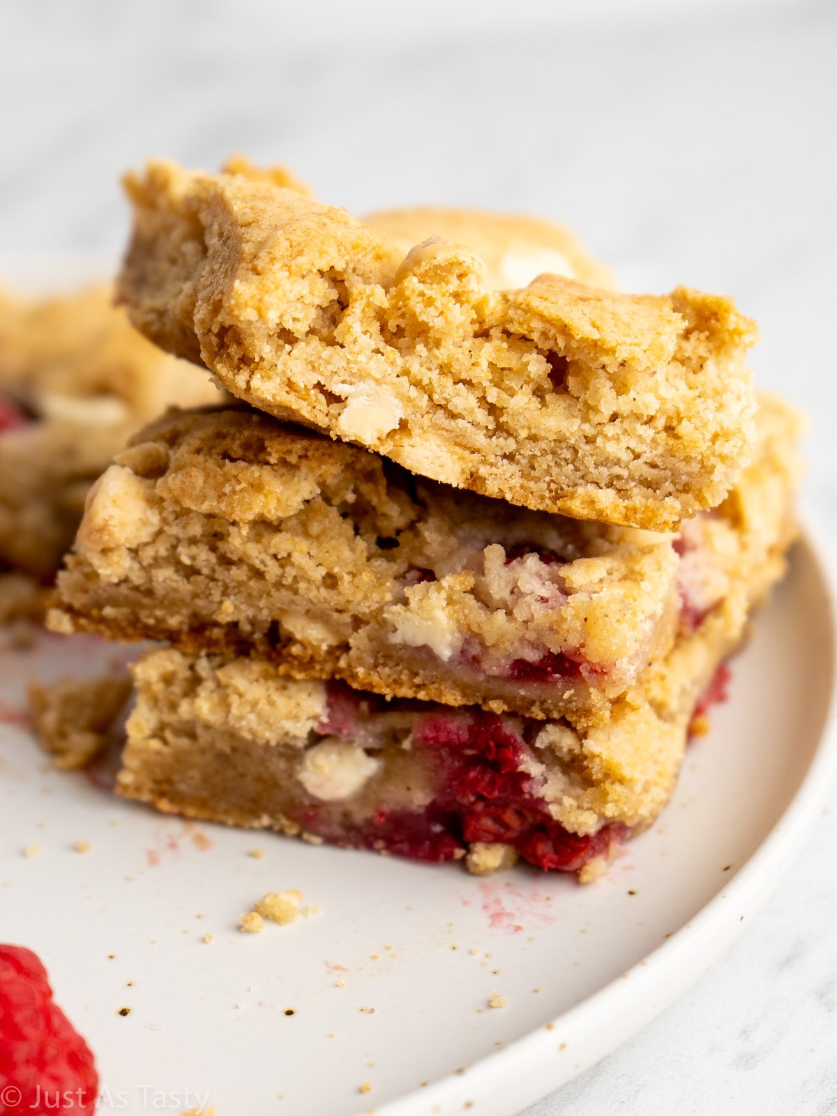 Close-up of a stack of three blondies on a white plate. 