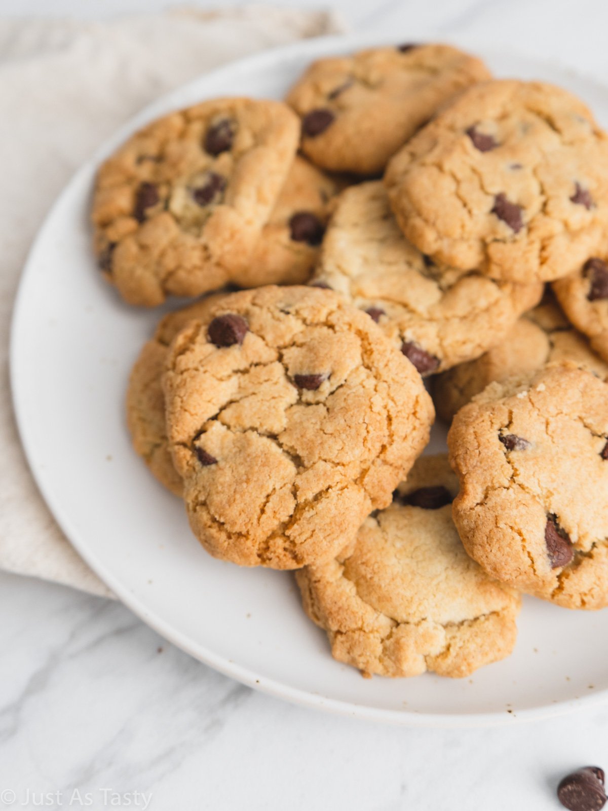 Air fryer cookies piled onto a white plate. 