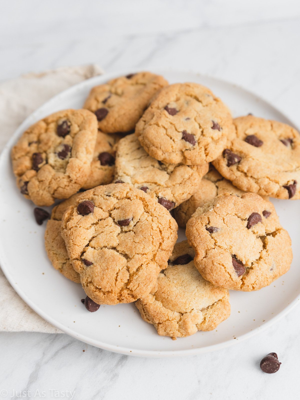 Chocolate chip cookies on a white plate. 