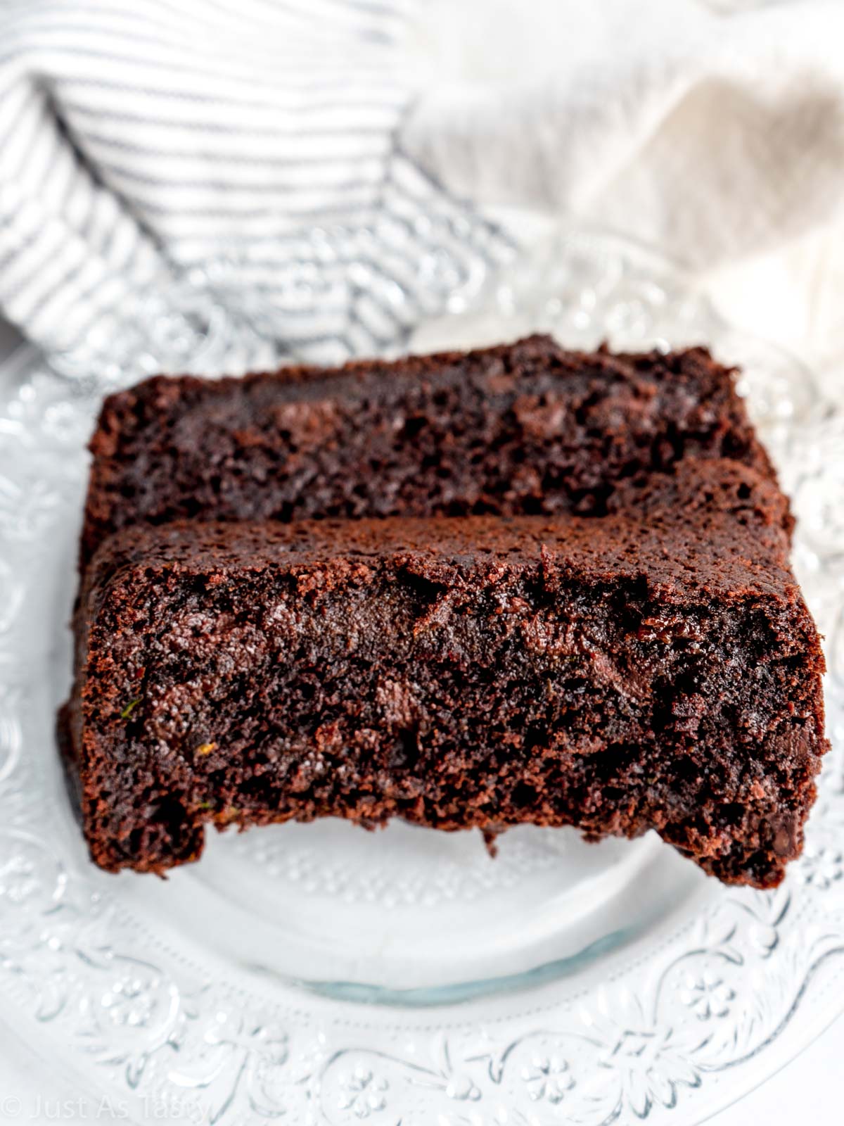 Two slices of chocolate zucchini bread on a plate. 