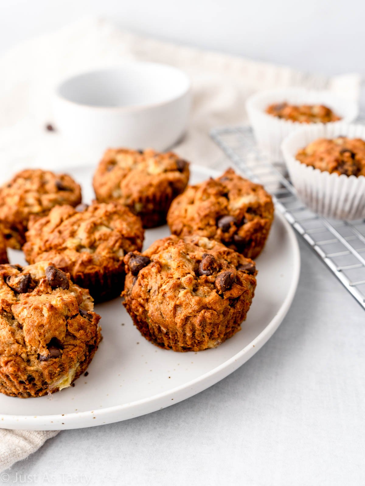 Banana chocolate chip muffins on a white plate.