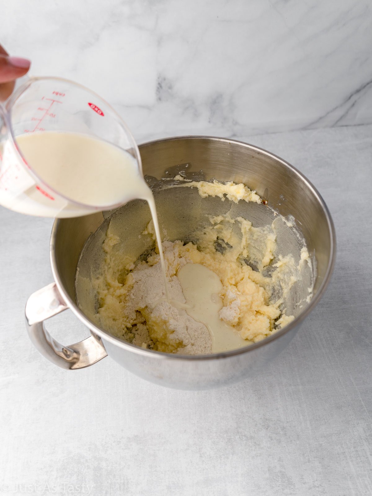 Buttermilk being poured into mixing bowl.