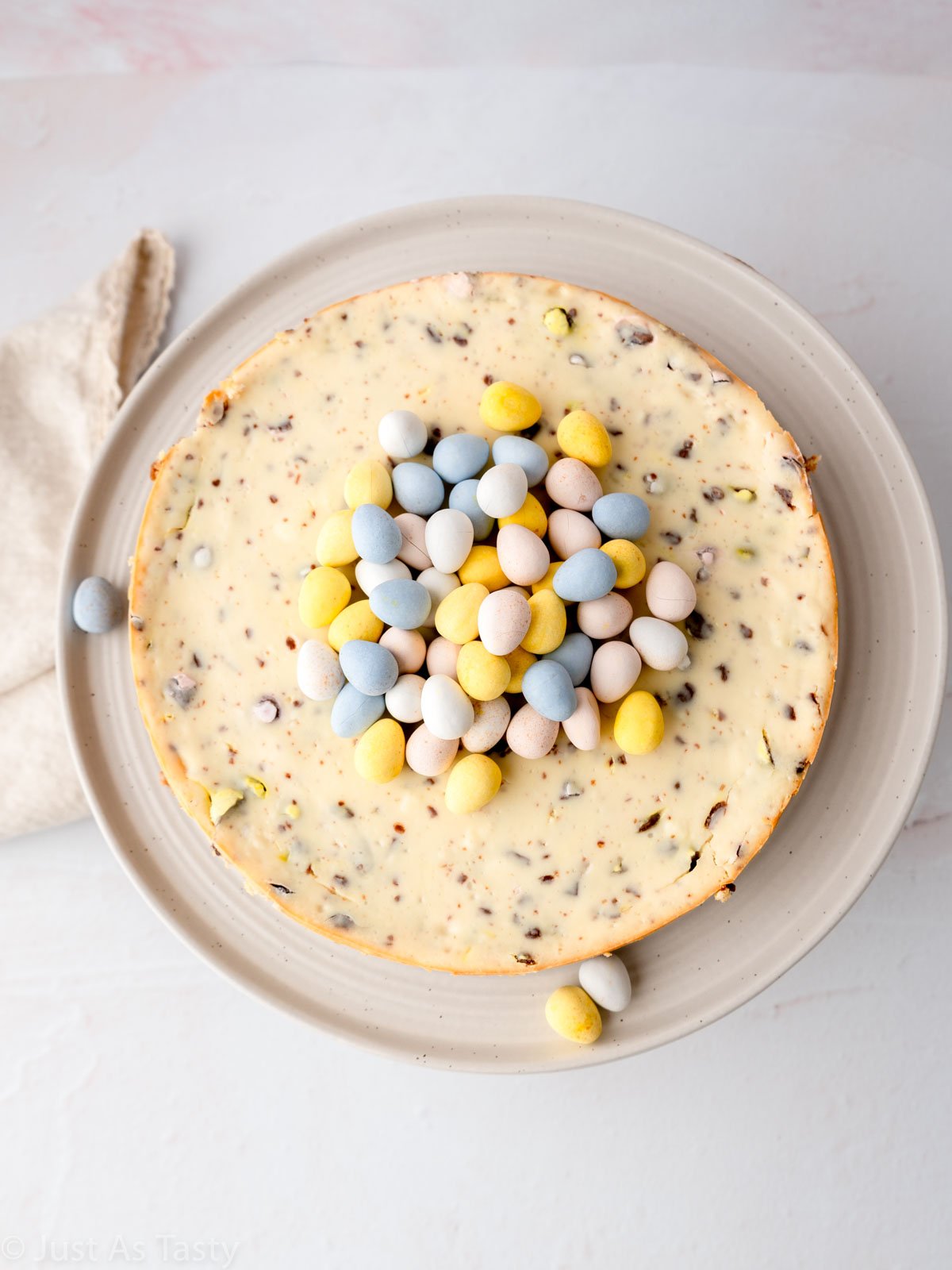 Cheesecake topped with pastel chocolate mini eggs.