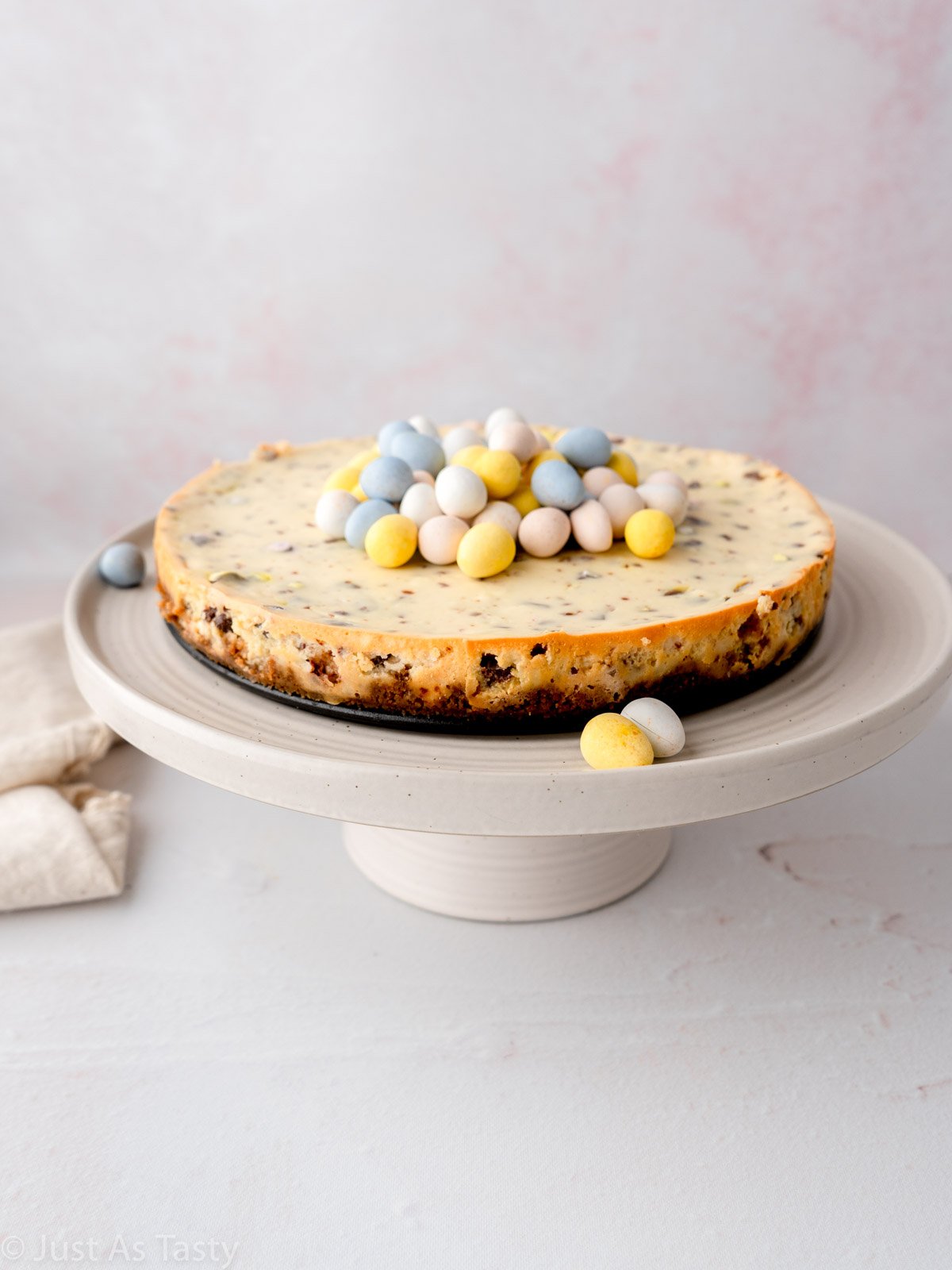 Easter egg cheesecake on a cake stand.