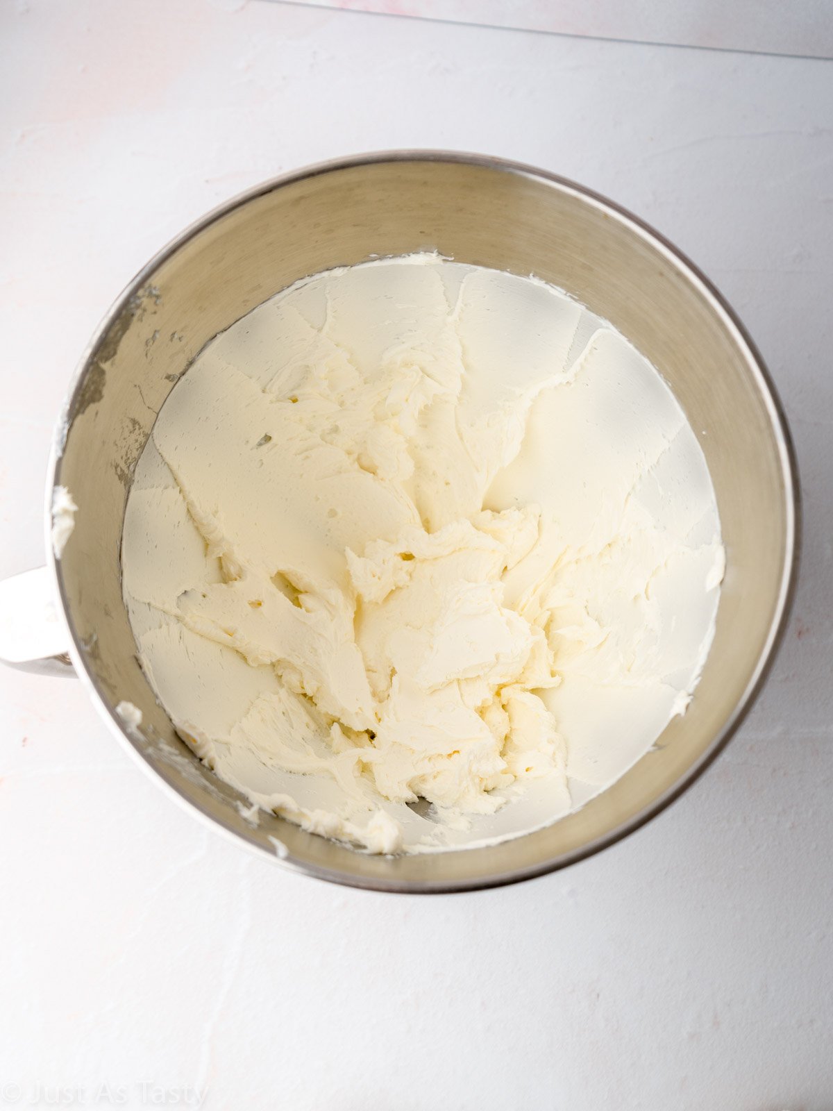 Cream cheese beaten in a mixing bowl.