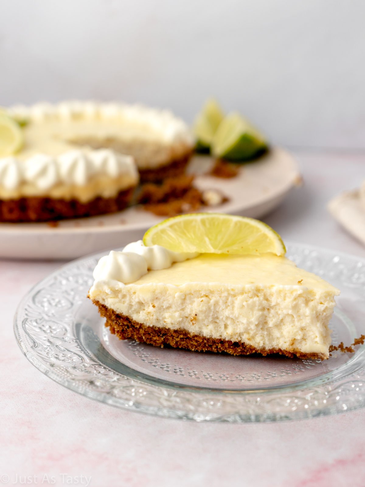 Slice of key lime pie on a glass plate.