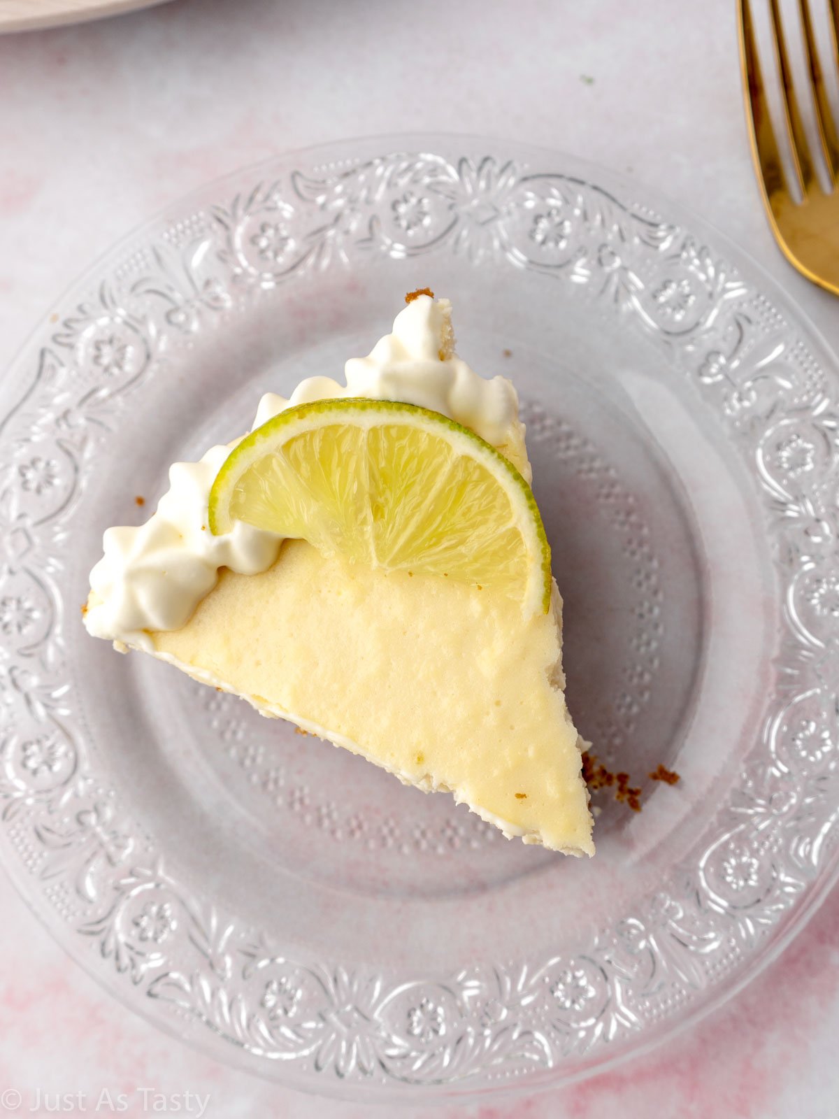 Slice of gluten free key lime pie on a glass plate.