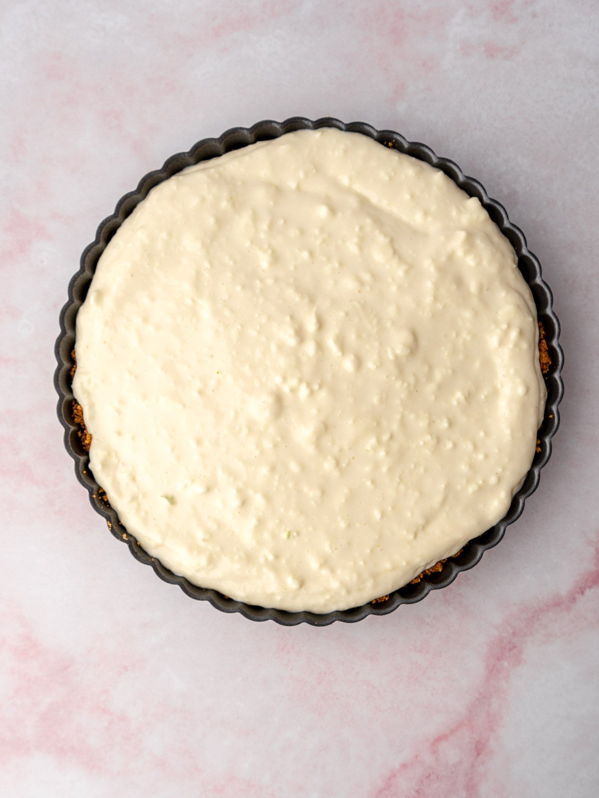 Pie filling in a tart pan.