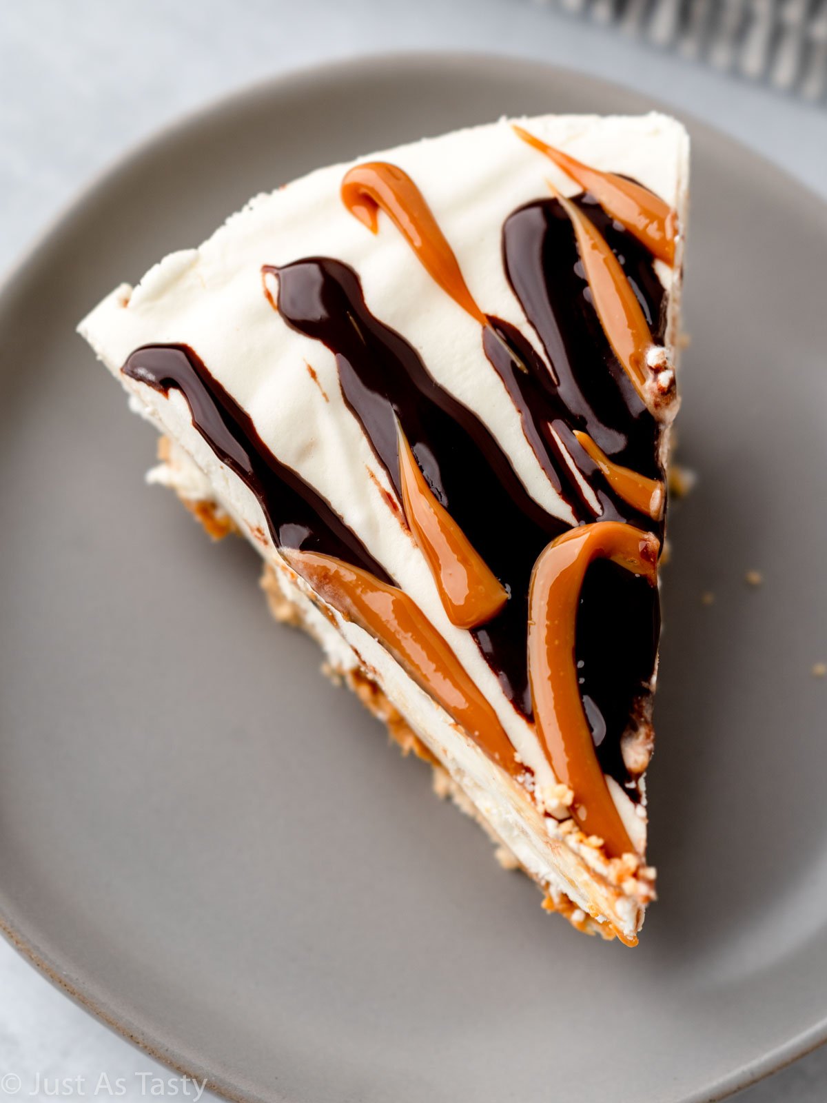 Slice of caramel banana pie on a grey plate. 