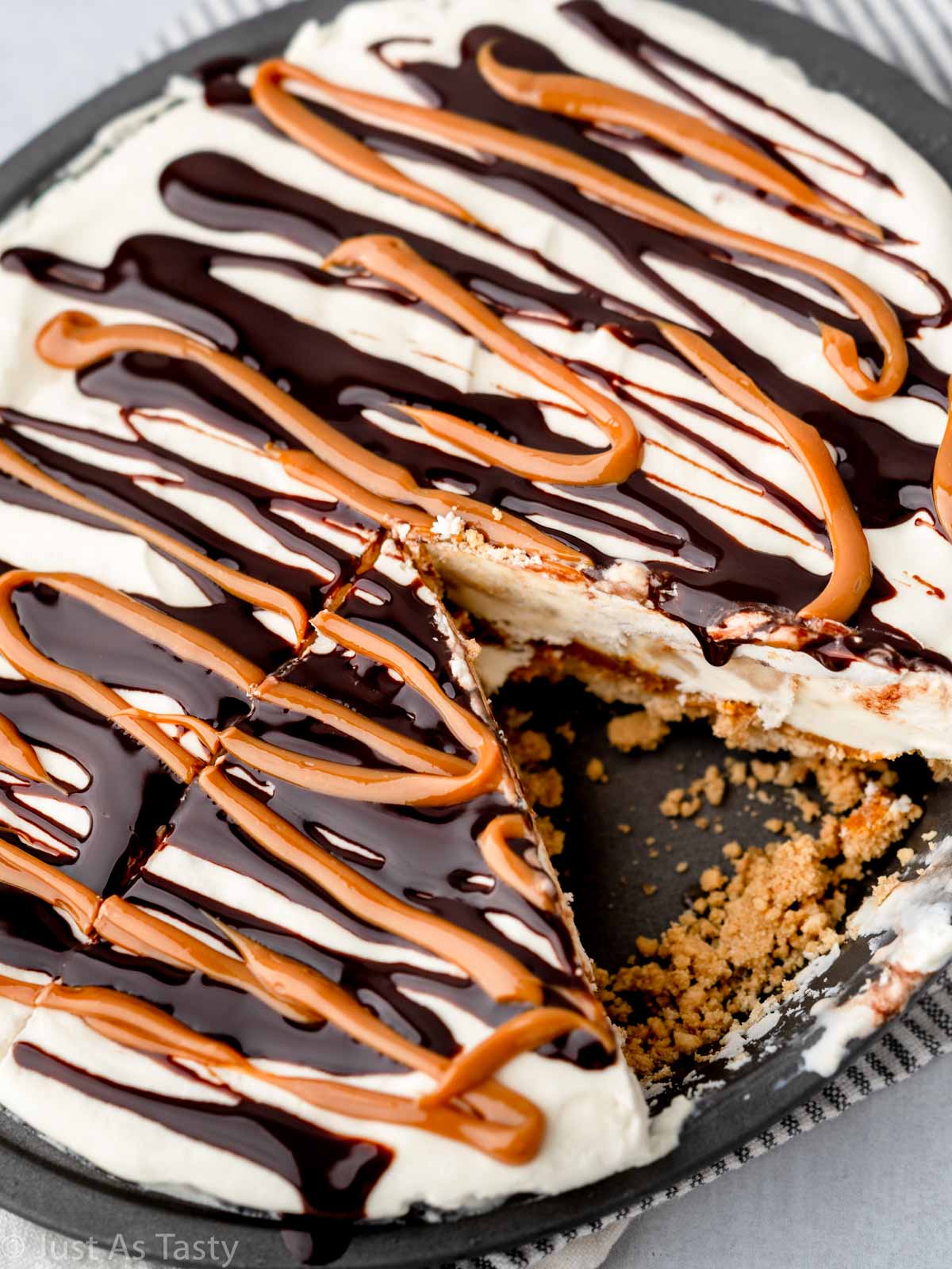 Caramel banana pie in a pie plate with a slice missing. 