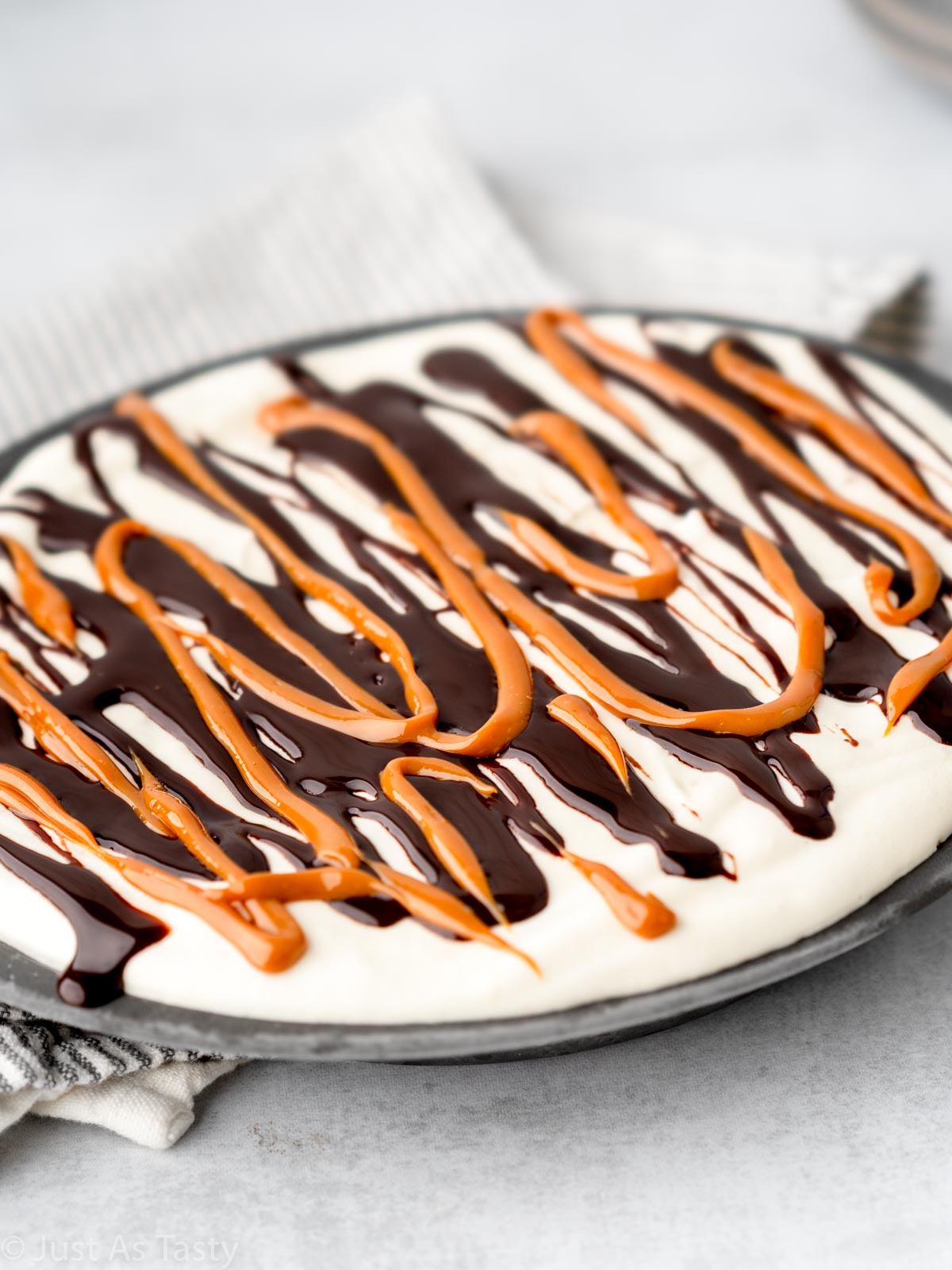 Banoffee ice cream pie topped with chocolate sauce and dulce de leche.