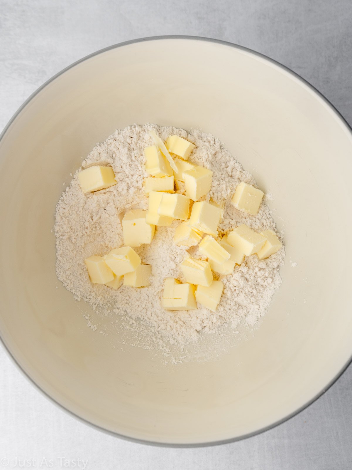 Cubes of butter and flour in a mixing bowl.