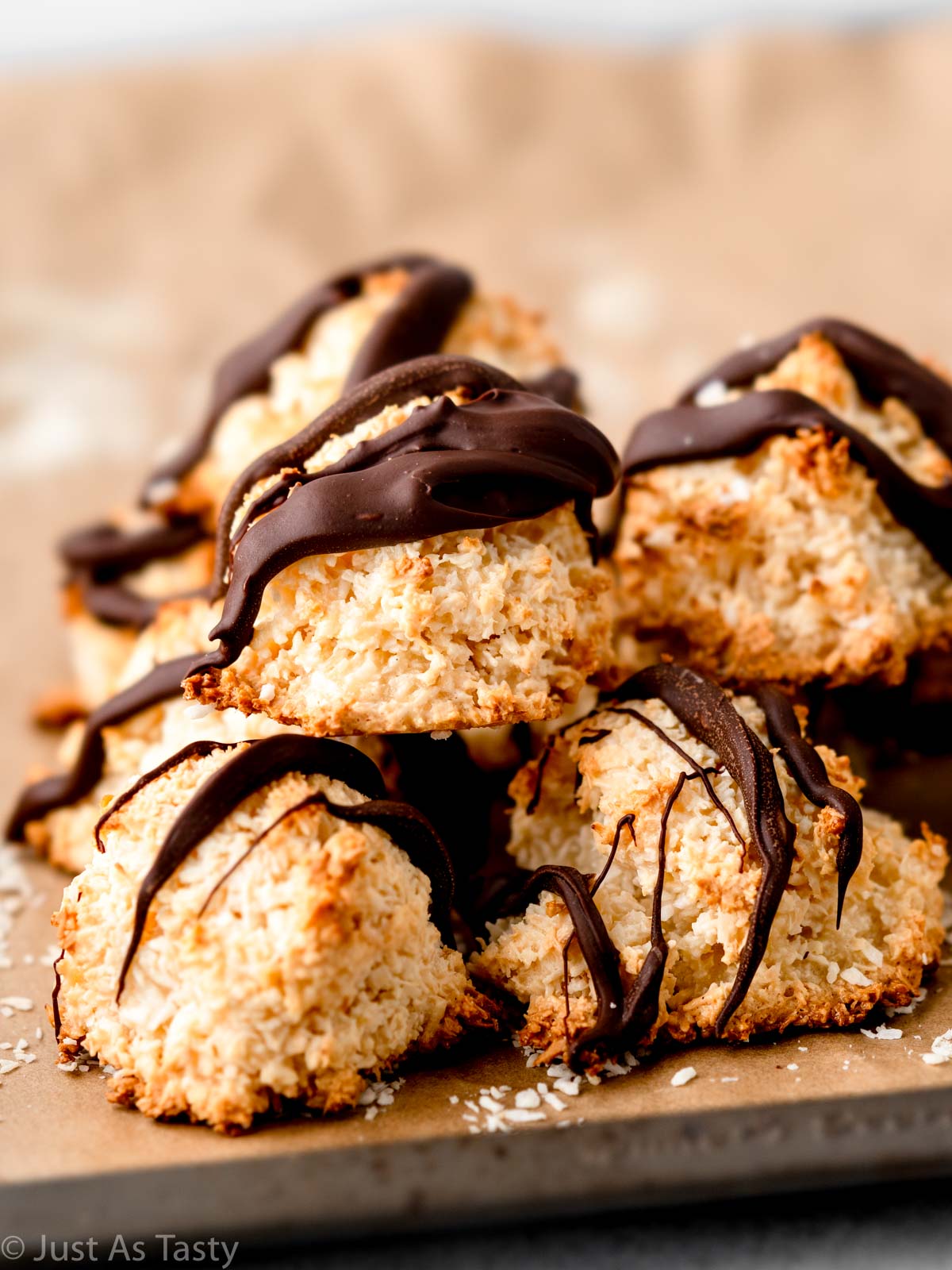 Stack of coconut macaroons drizzled with chocolate. 