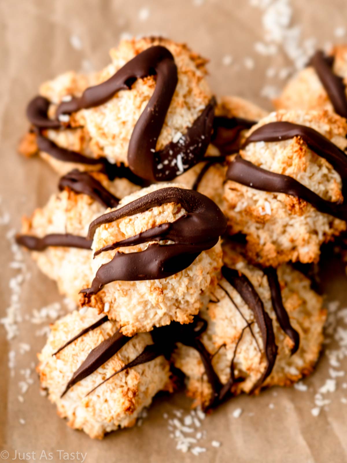 Pile of chocolate coconut macaroons on parchment paper.