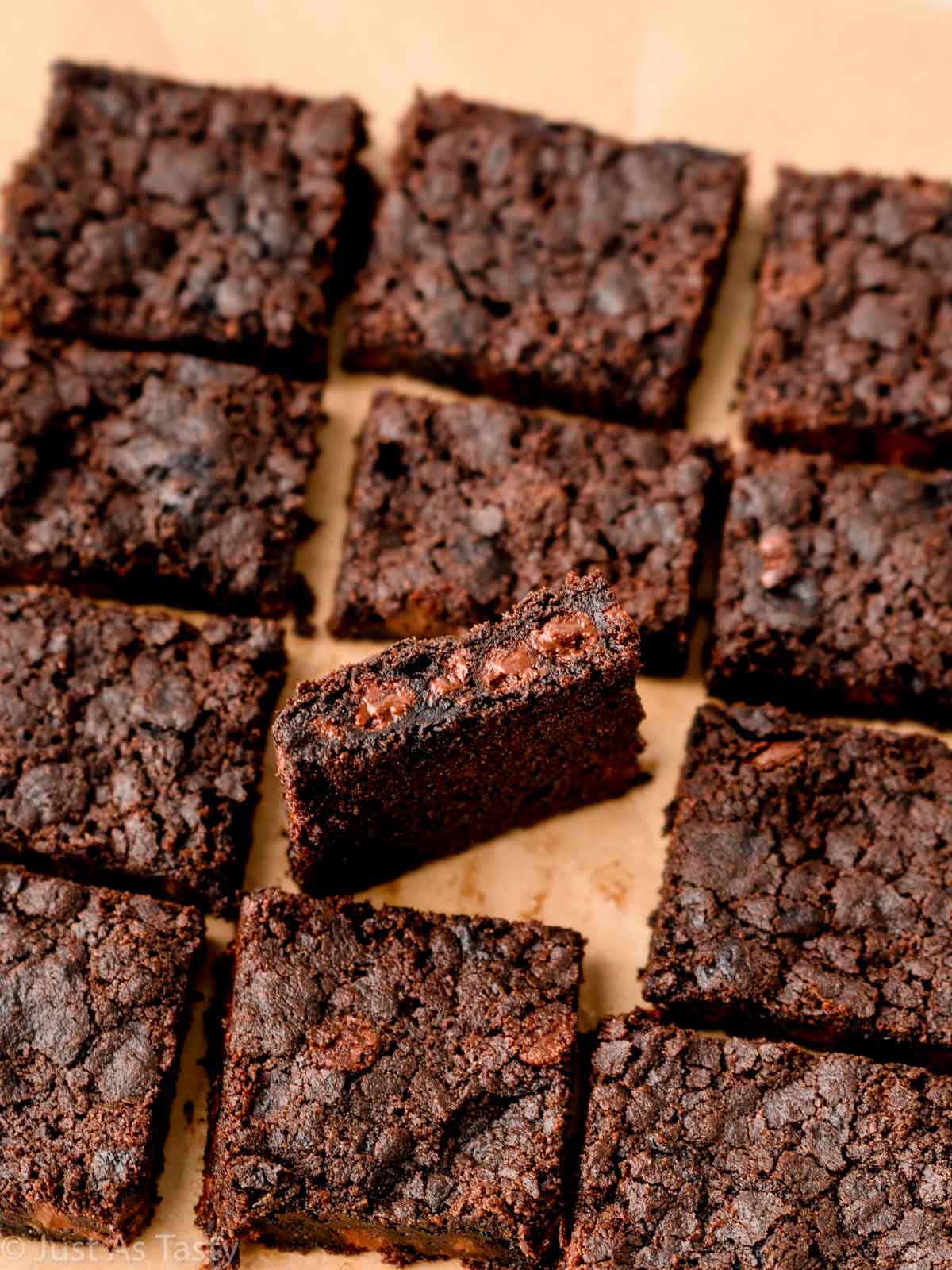 Gluten free dairy free brownies on parchment paper.