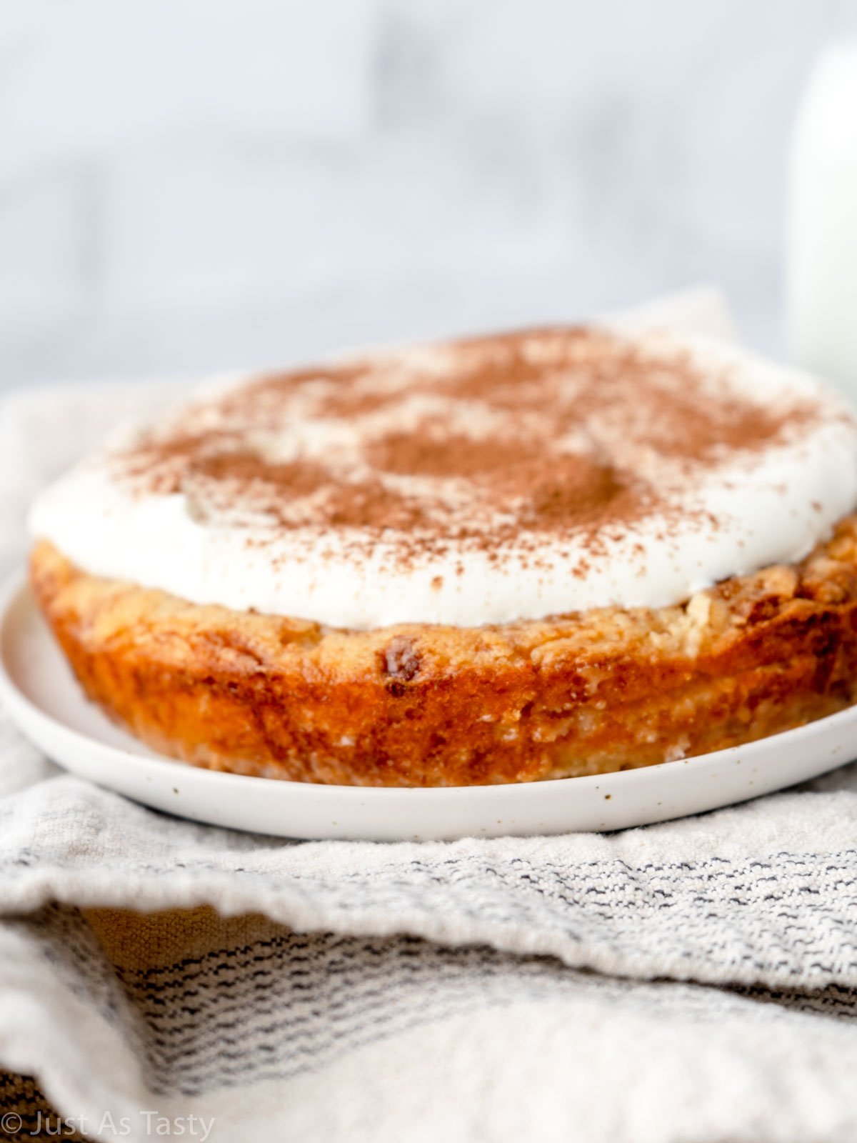 Gluten free tres leches cake on a white plate. 