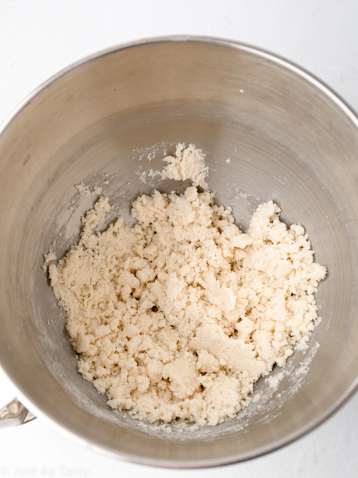 Shortbread crust dough in a mixing bowl.