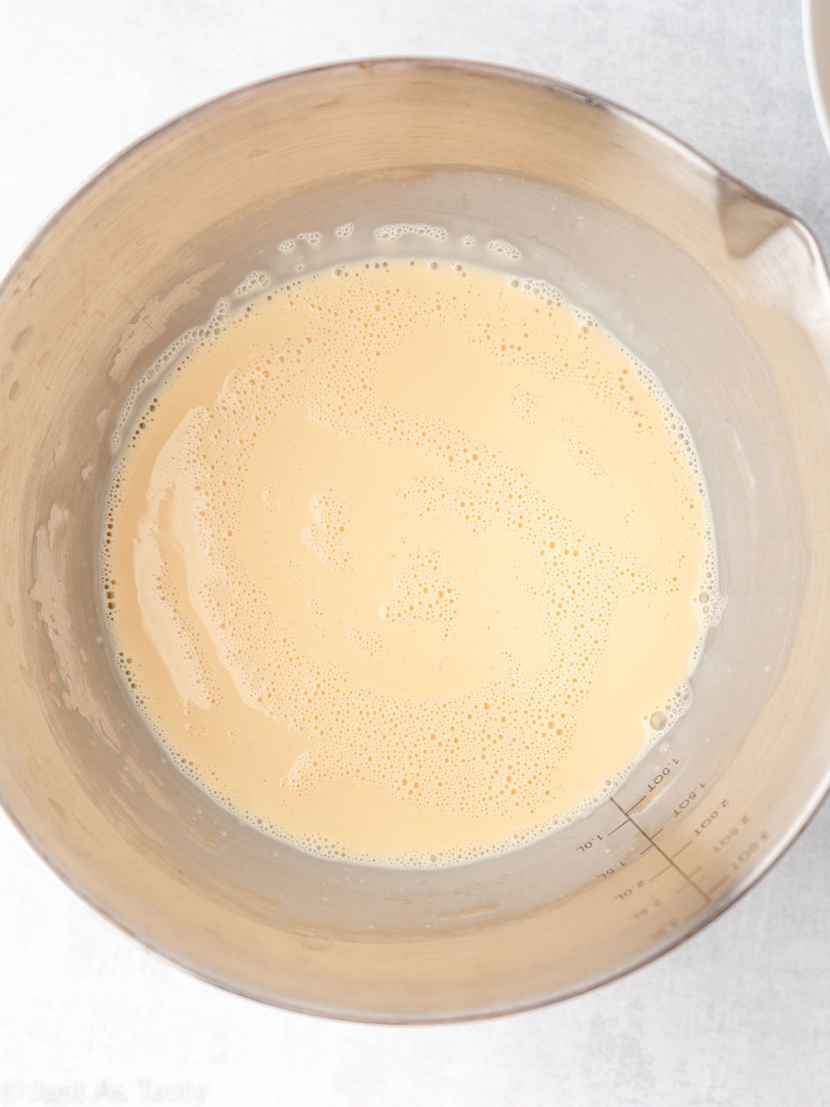 Three milk mixture for tres leches cake in a bowl.