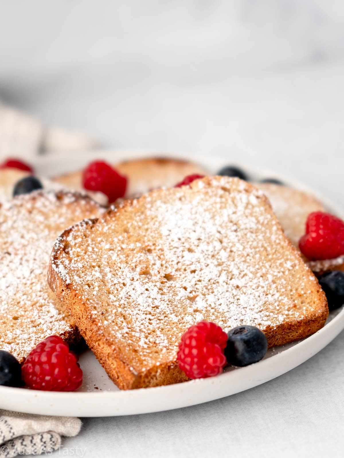 Close-up of air fryer French toast dusted with powdered sugar. 