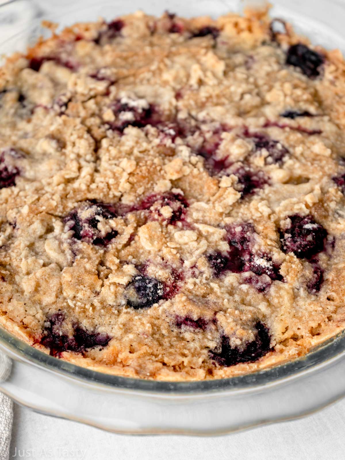 Close-up of blackberry pie with crumble topping.