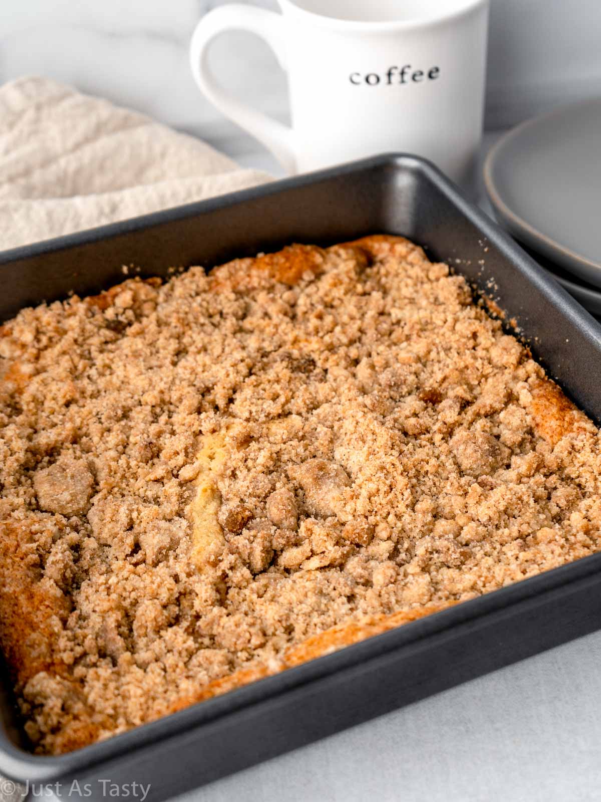 Cinnamon streusel coffee cake in a square baking pan. 