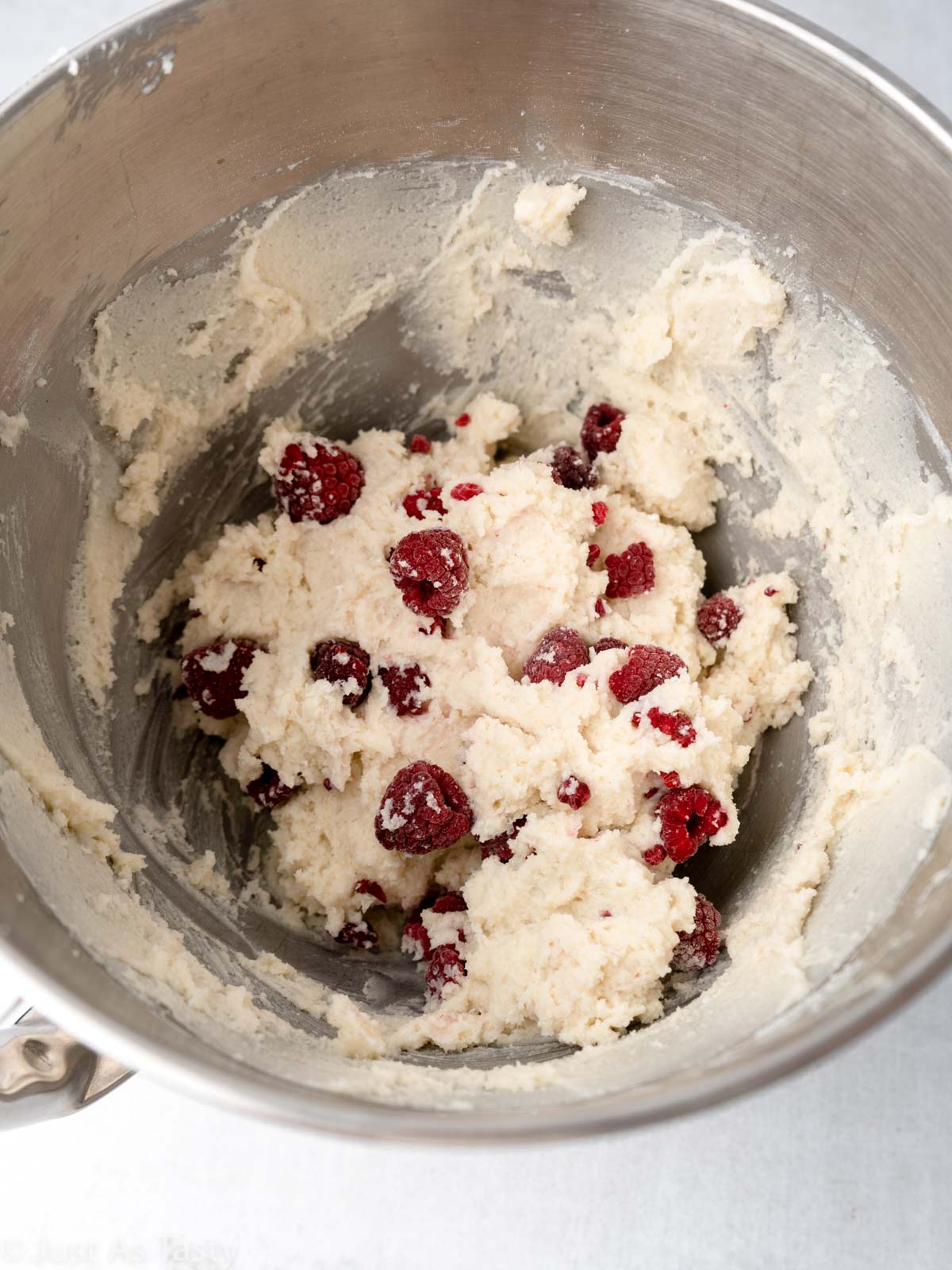 Cake batter with raspberries in a bowl. 