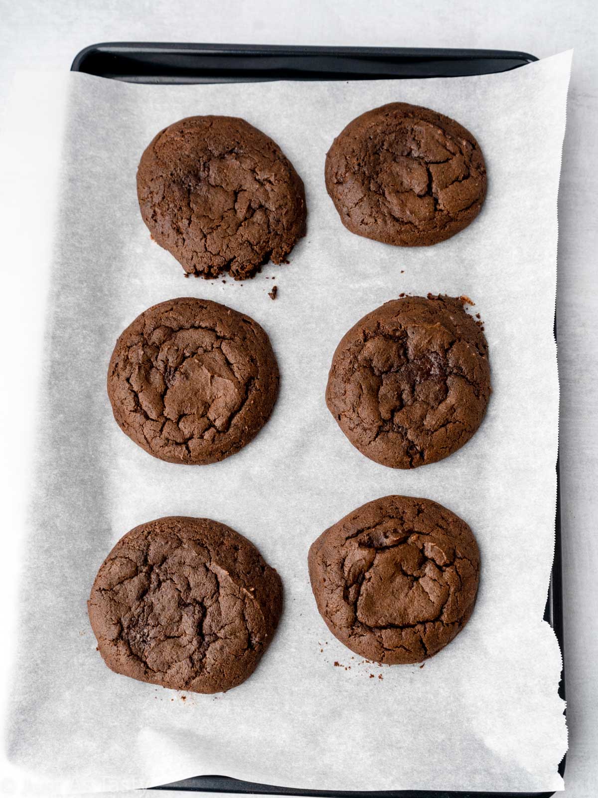 Chocolate whoopie pie cookies on a baking sheet.