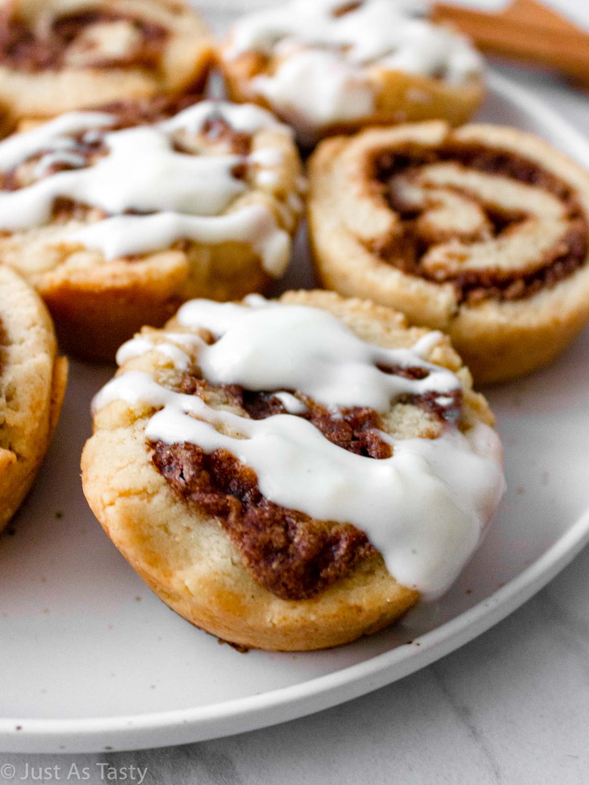 Close-up of a gluten free cinnamon roll topped with icing. 