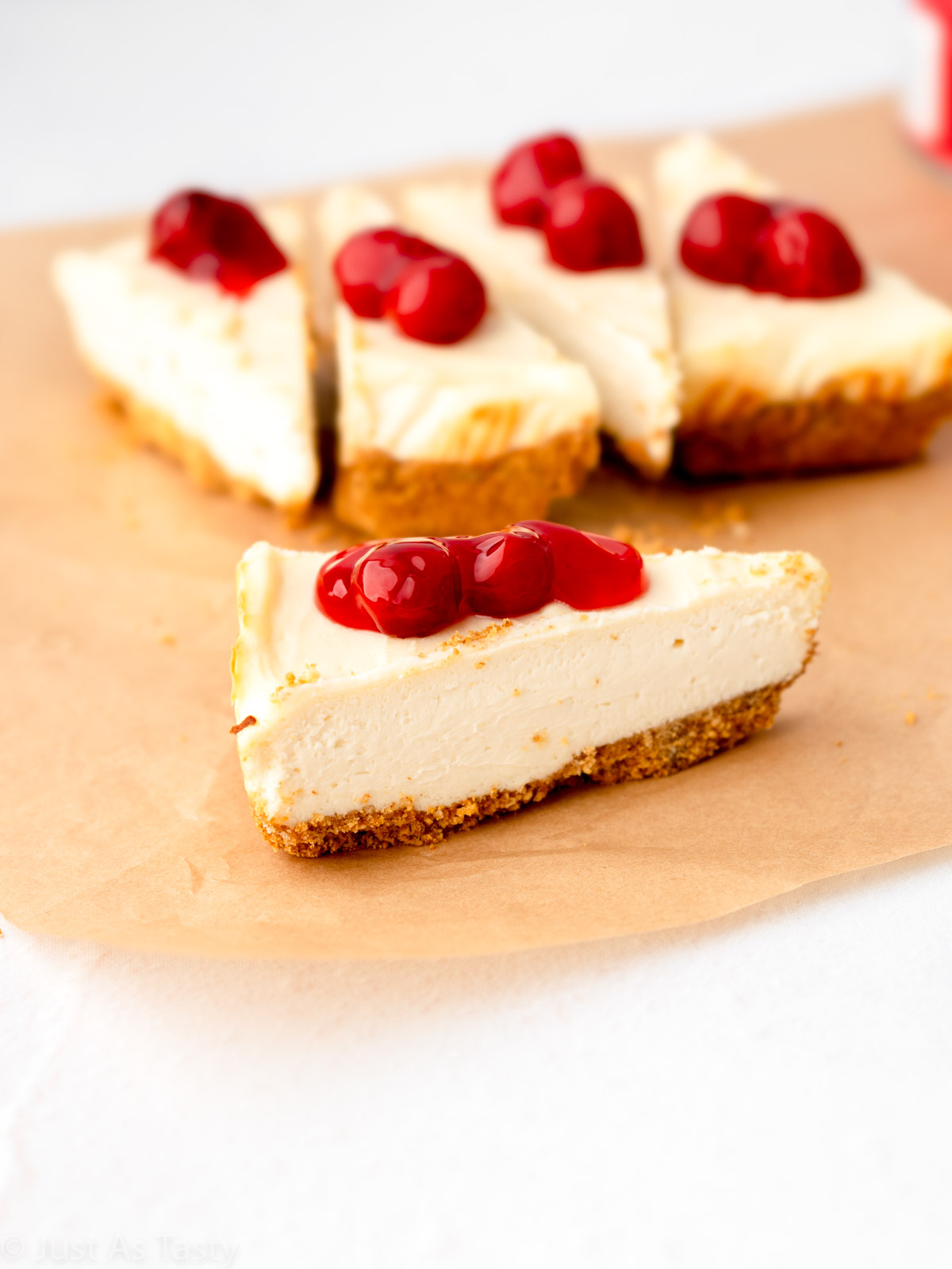 Slice of cheesecake topped with cherry topping.