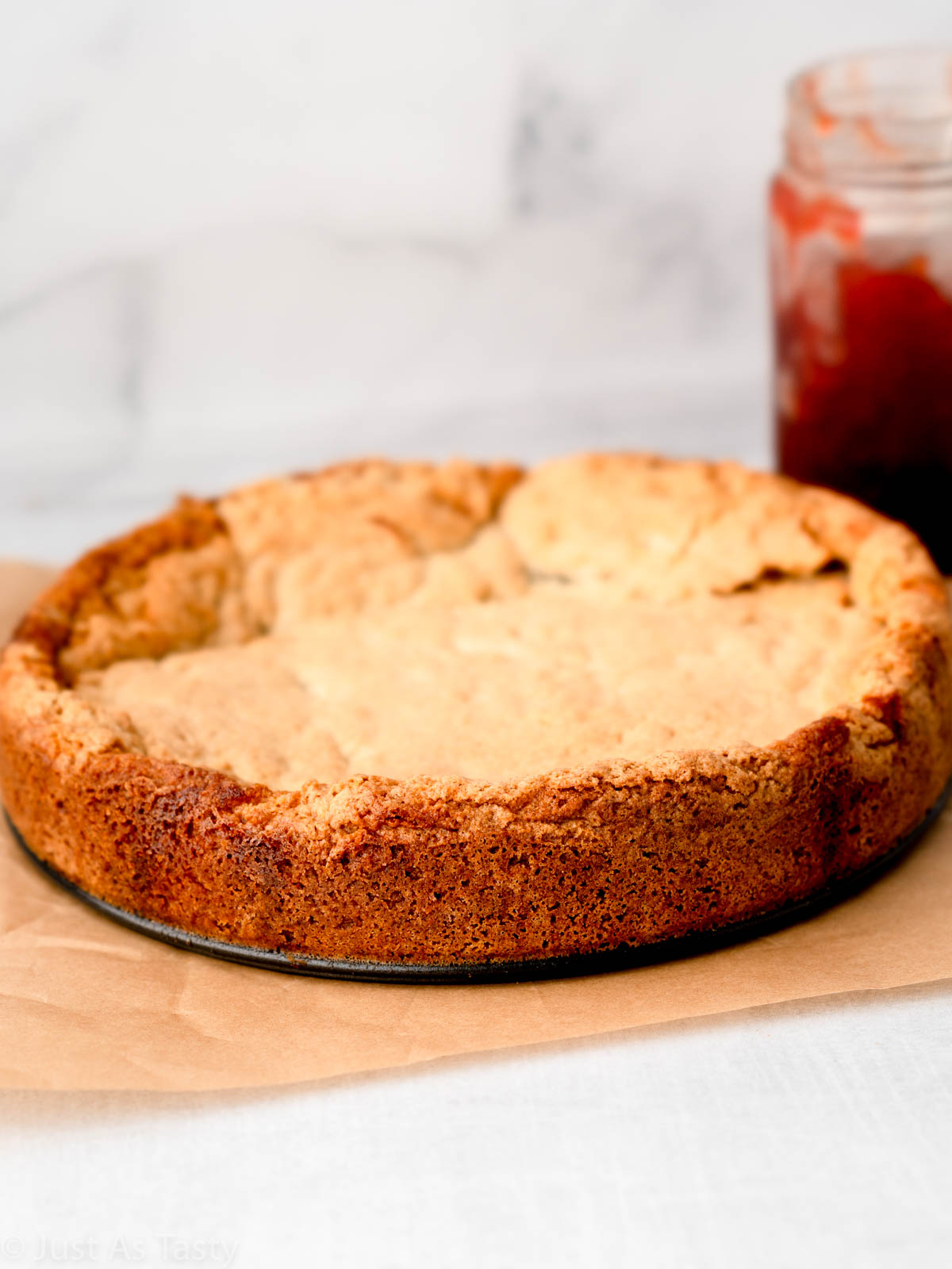 Strawberry jam cake on parchment paper.