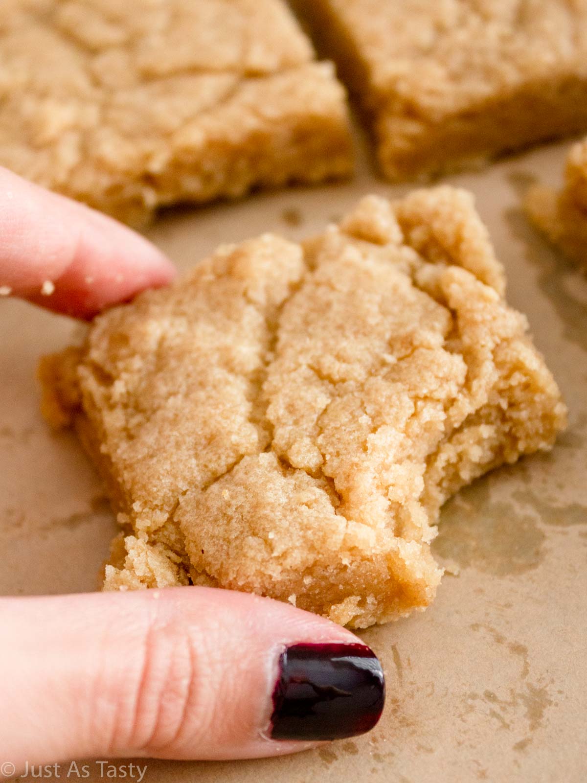 Close-up of a blonde brownie with a bite taken out. 