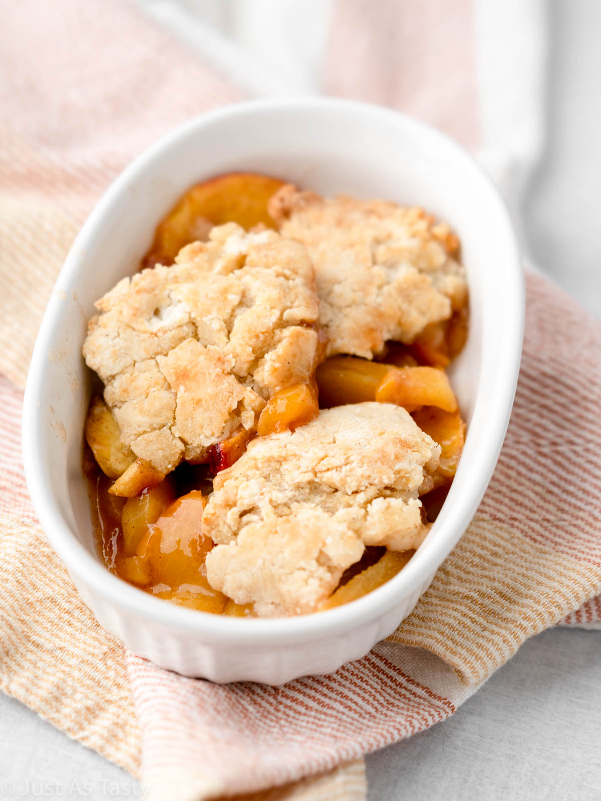 Gluten free peach cobbler in a bowl.