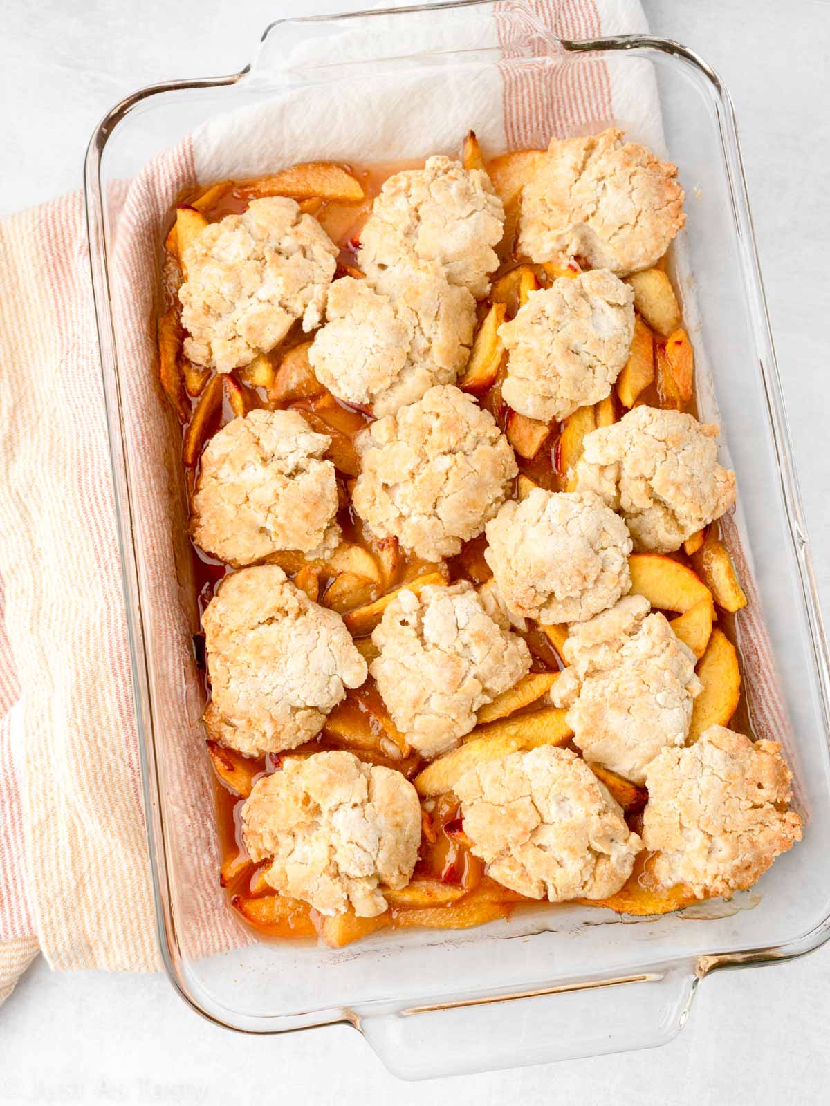 Peach cobbler in a glass baking dish. 