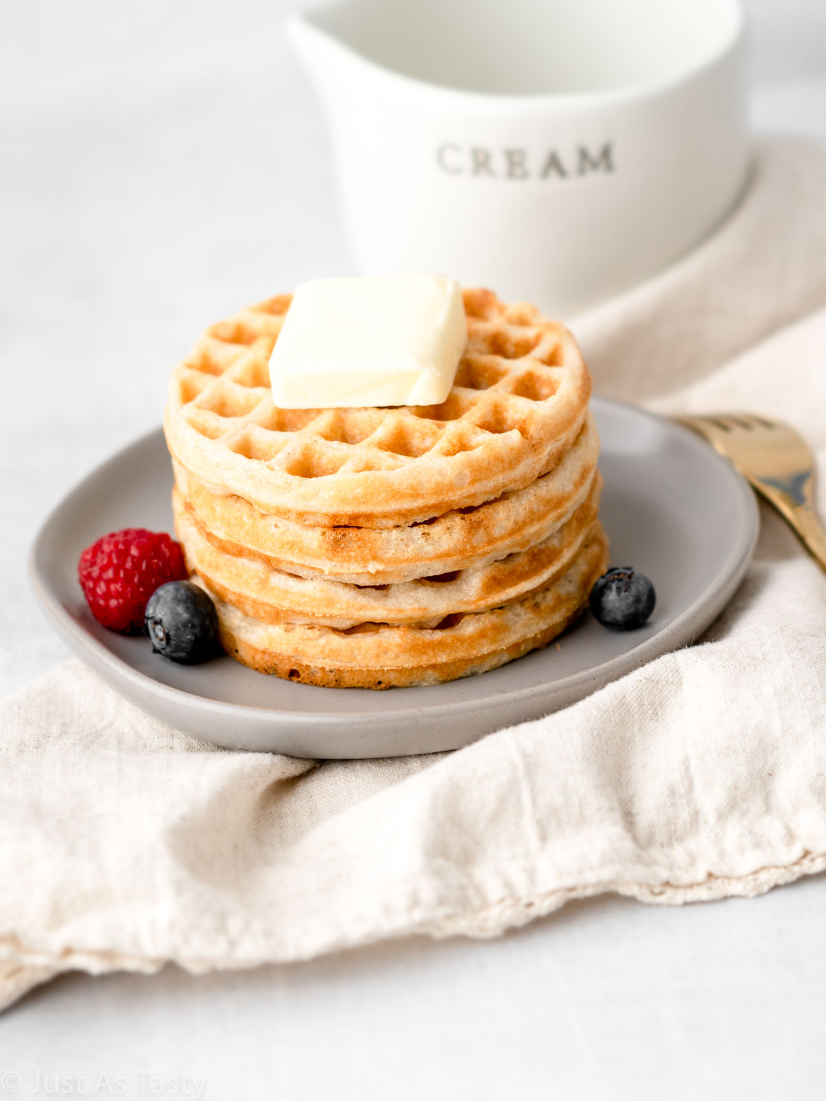 Waffles stacked on a plate.