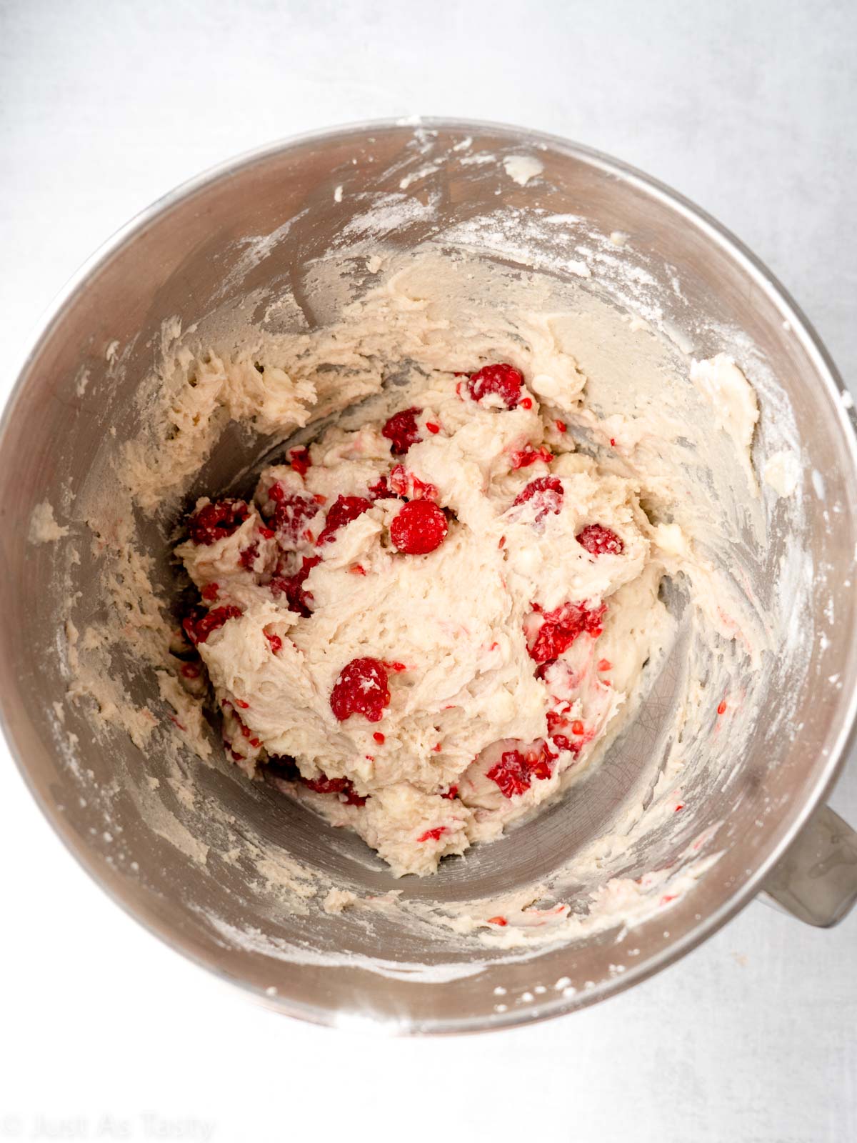 White chocolate raspberry muffin batter in a bowl.