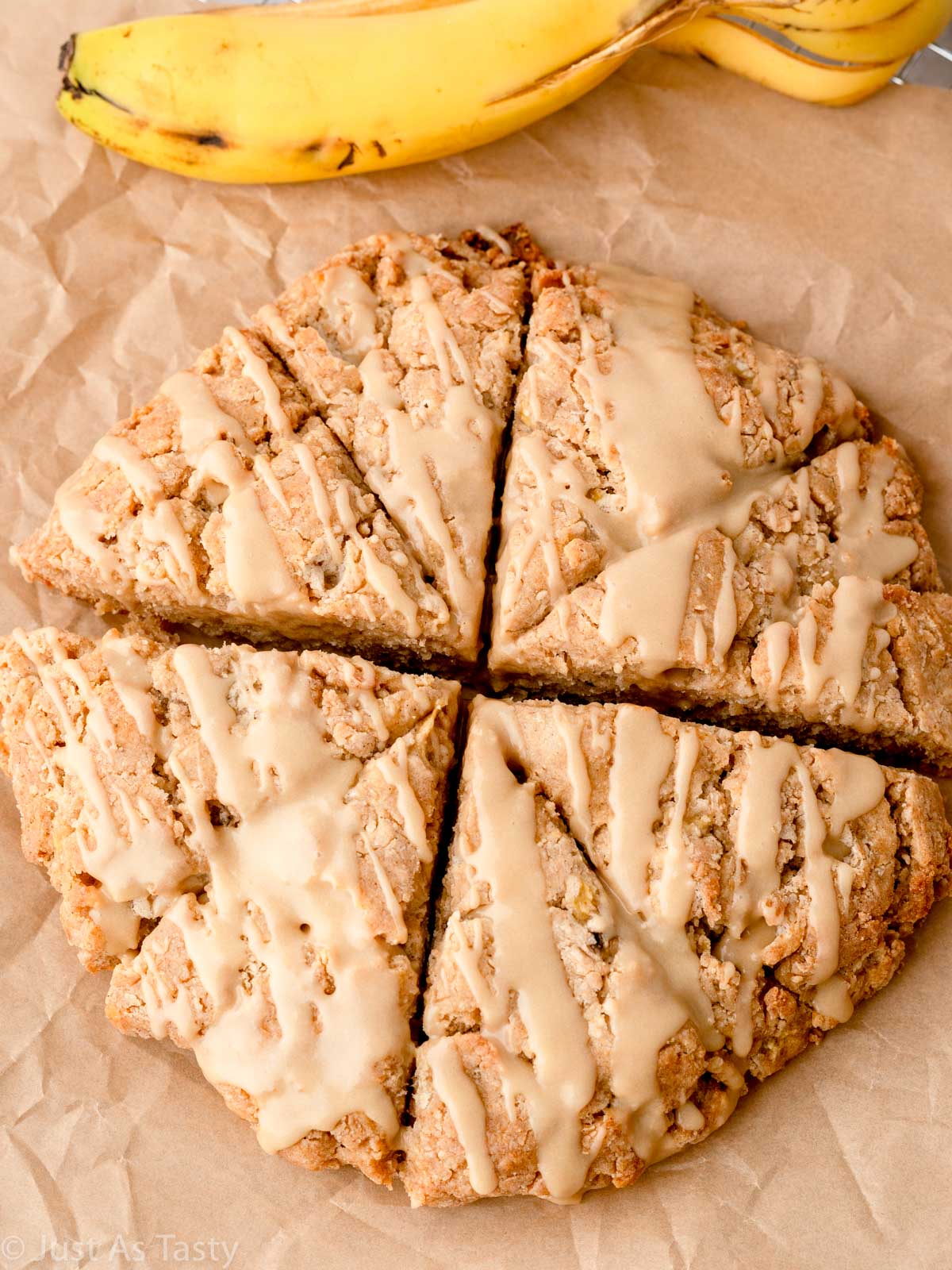 Glazed banana scones on brown parchment. 