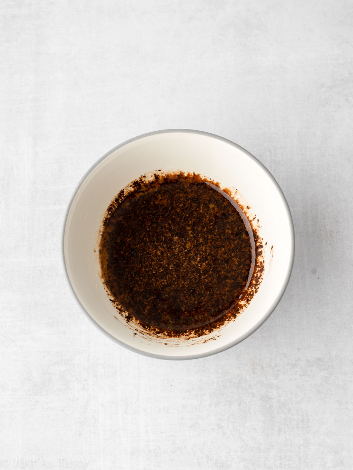 Melted butter mixed with espresso powder in a bowl.