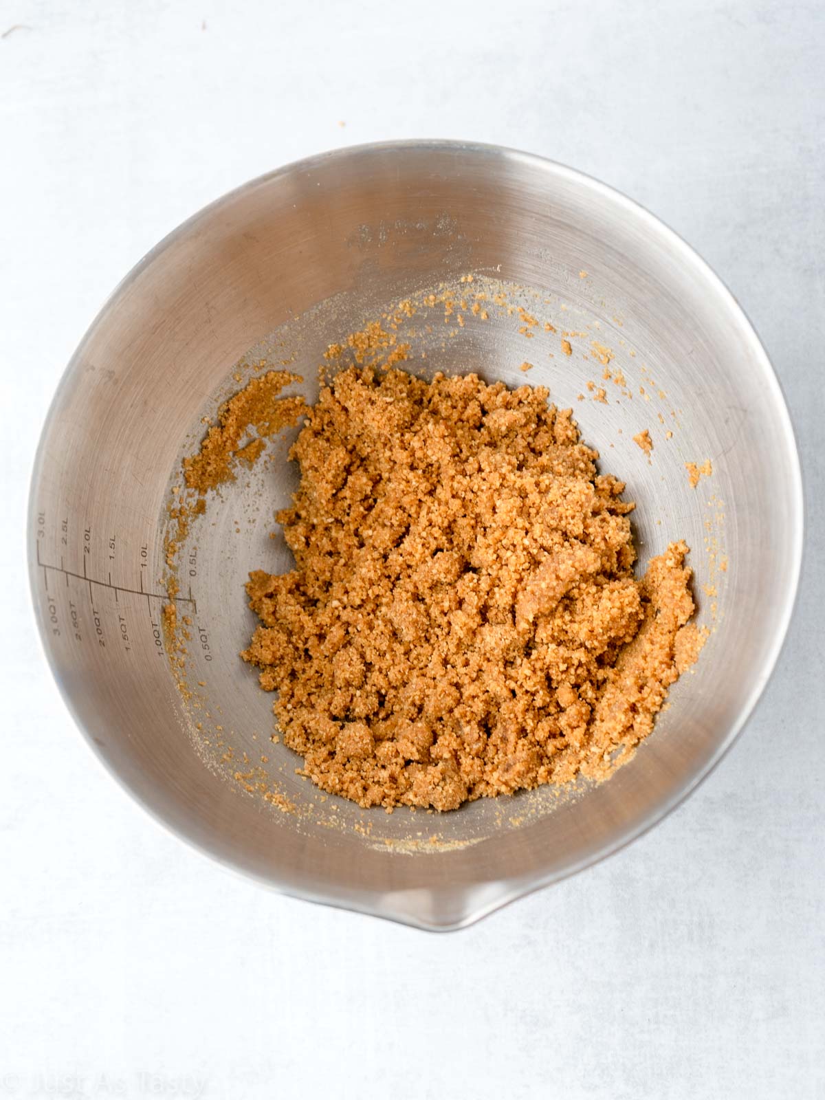 Graham cracker crust mixture in a bowl.