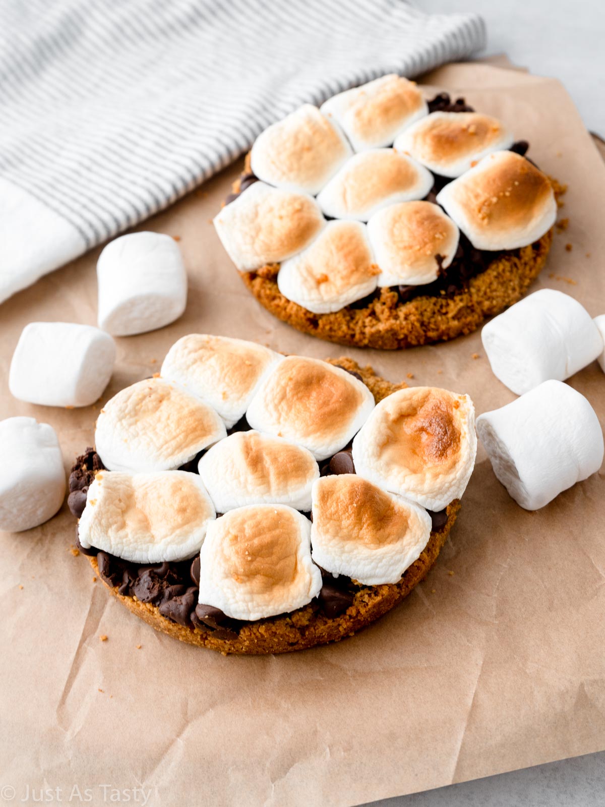 Two mini s'mores pies topped with burnt marshmallows. 