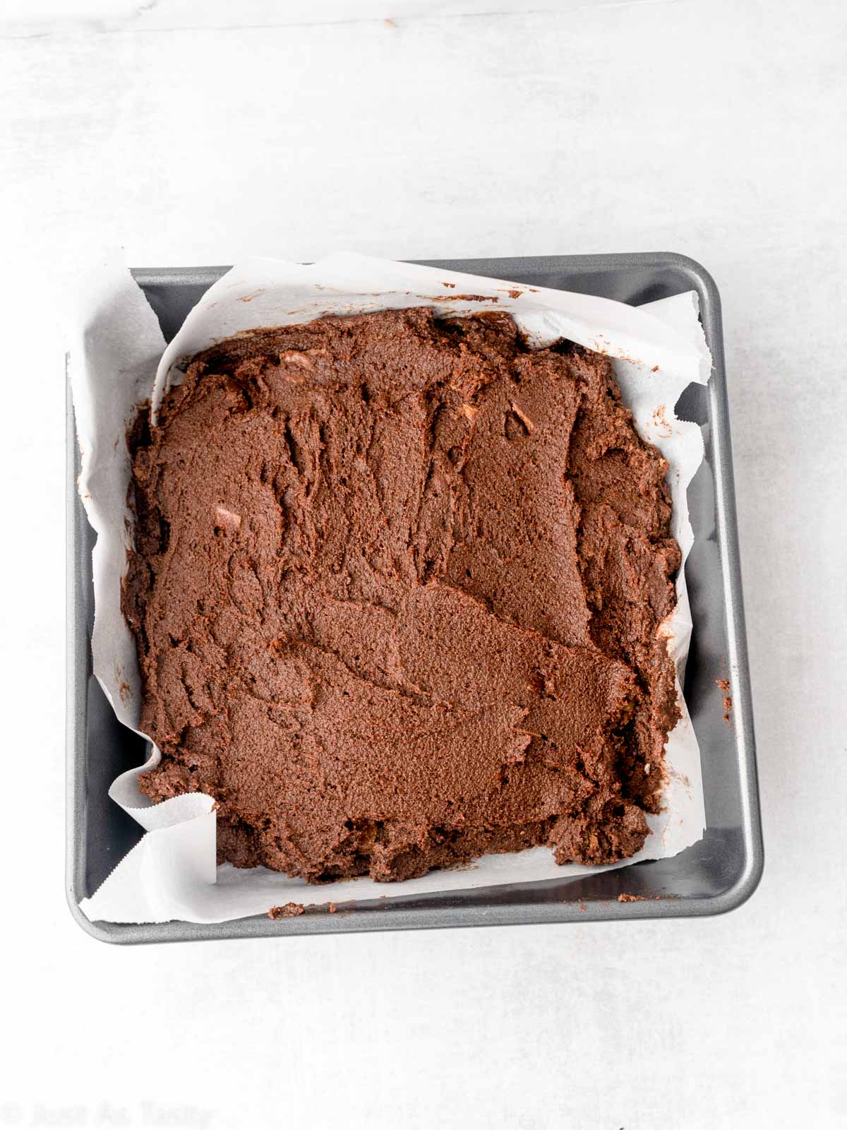Brownie batter in a pan.