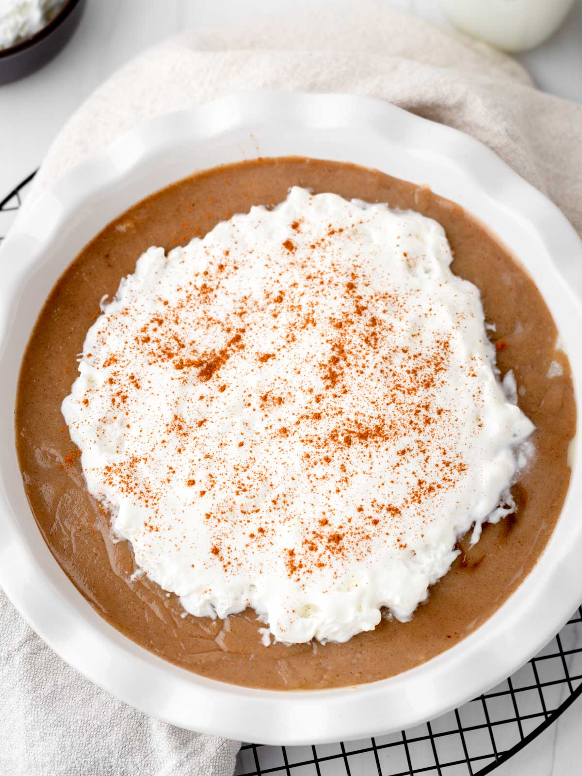 Butterscotch cinnamon pie topped with whipped cream.