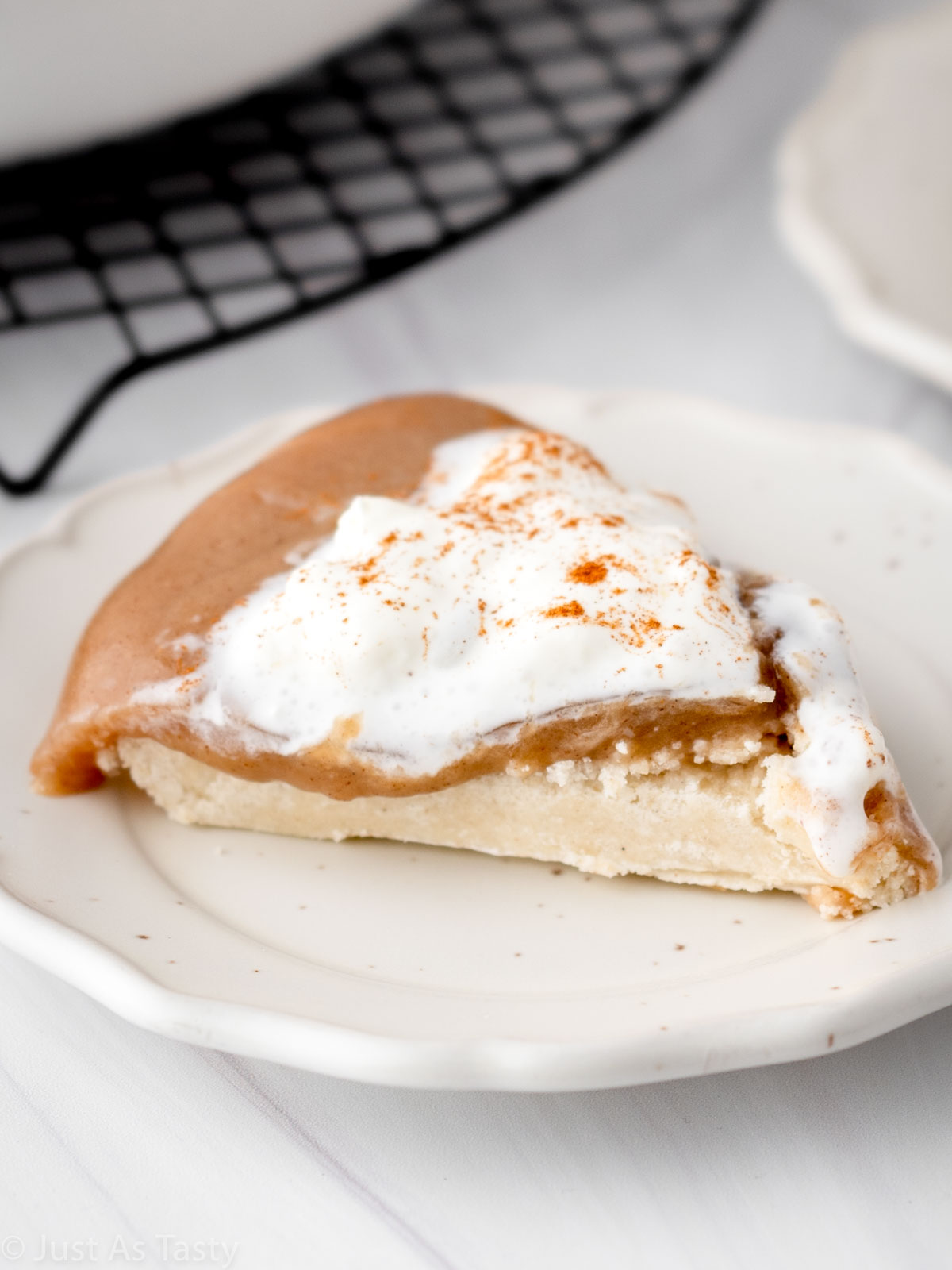 Slice of butterscotch cinnamon pie on a plate.